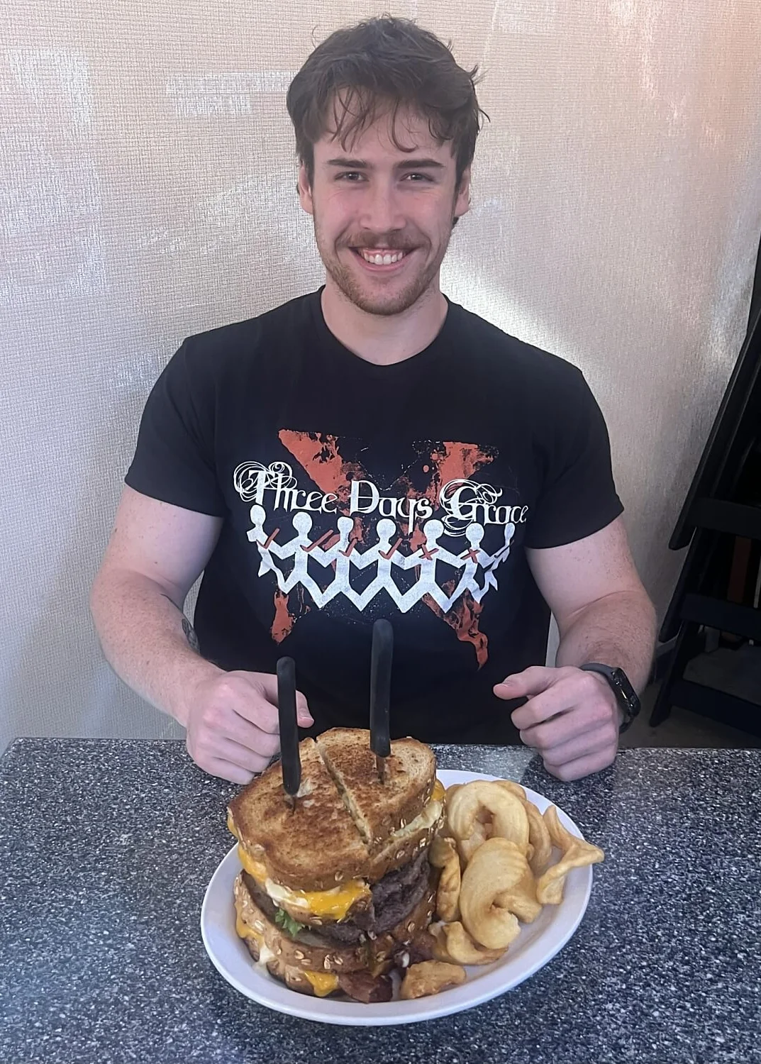 Giant cheeseburger stack with grilled cheese sandwich