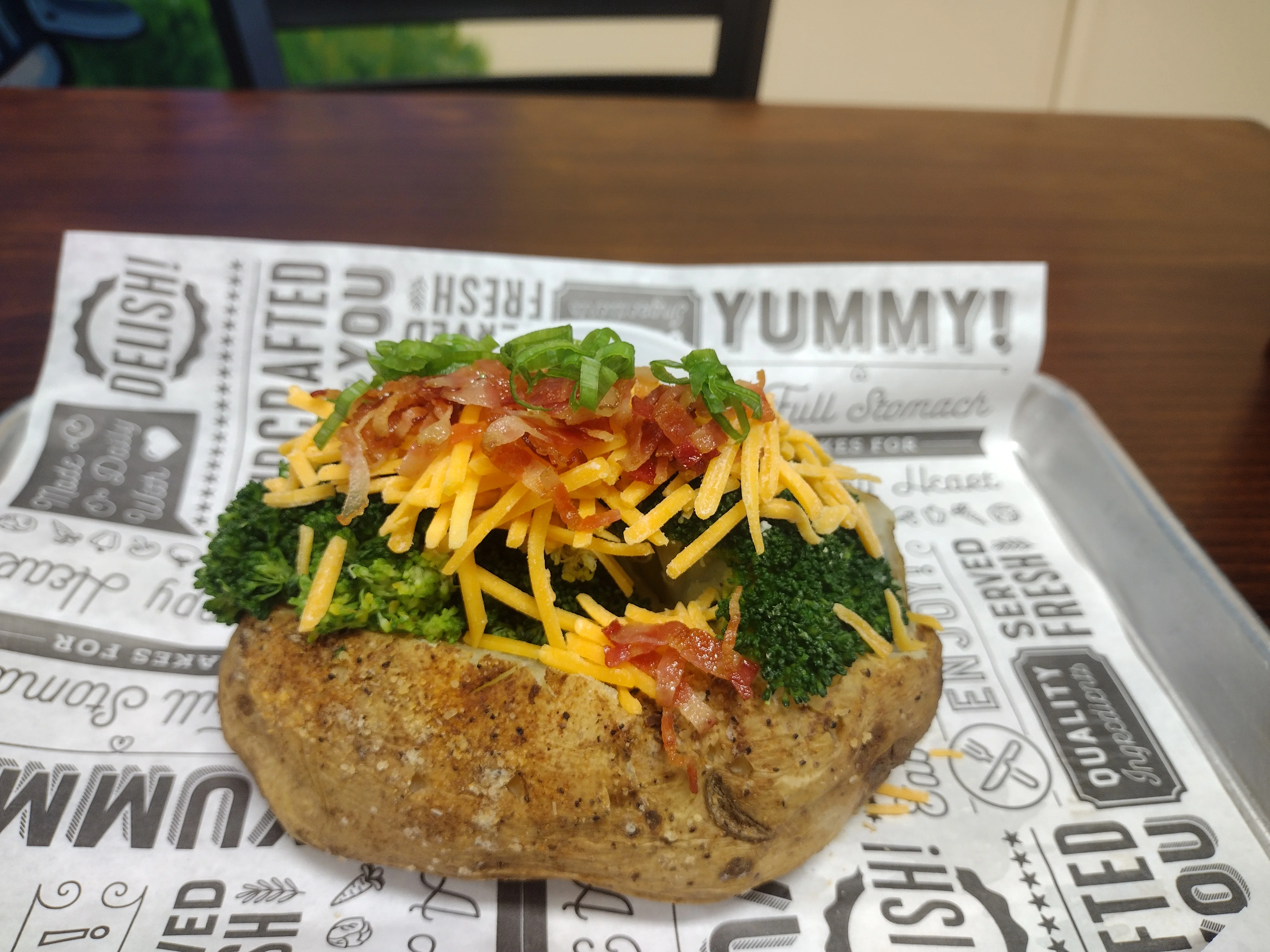 Baked potato topped with broccoli and cheese