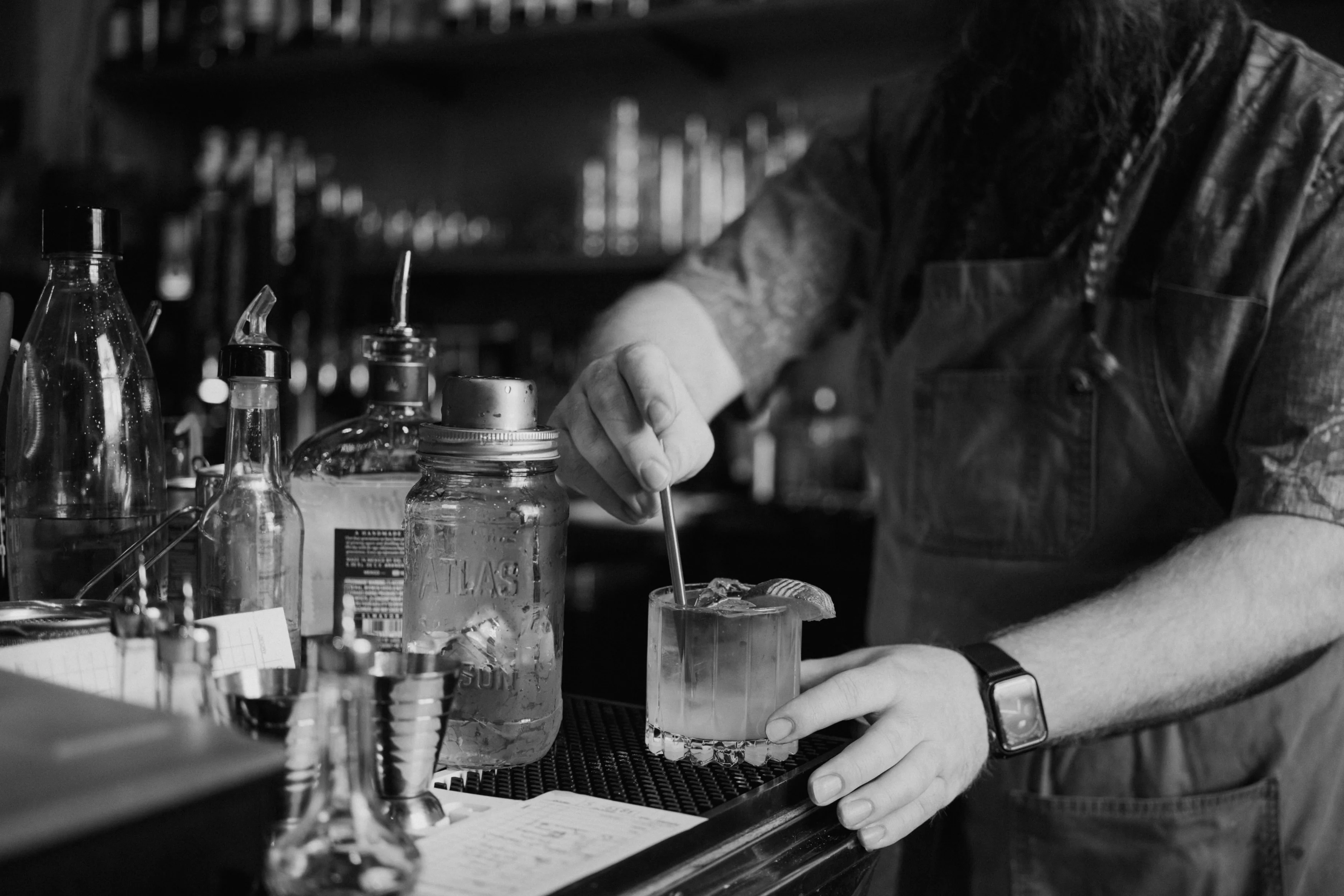Bartender mixing a cocktail at a stylish bar