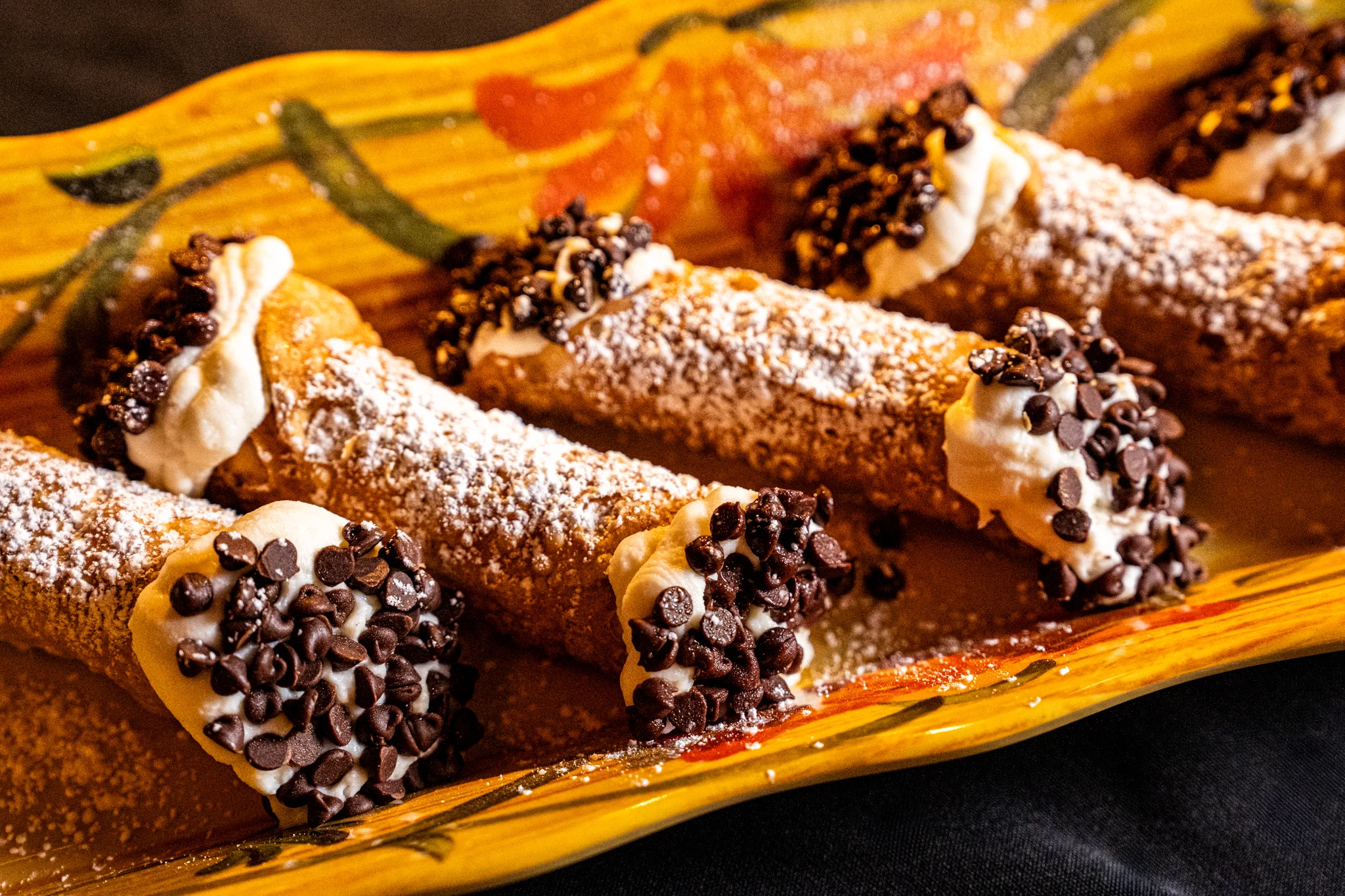 Sicilian cannoli with ricotta filling and chocolate chips on a dessert plate