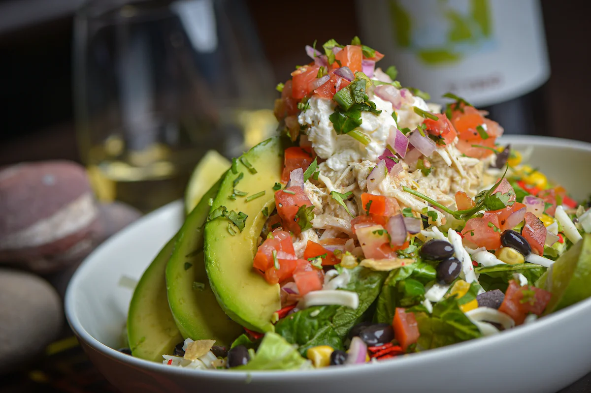 Vibrant Mexican chicken salad with avocado and fresh toppings