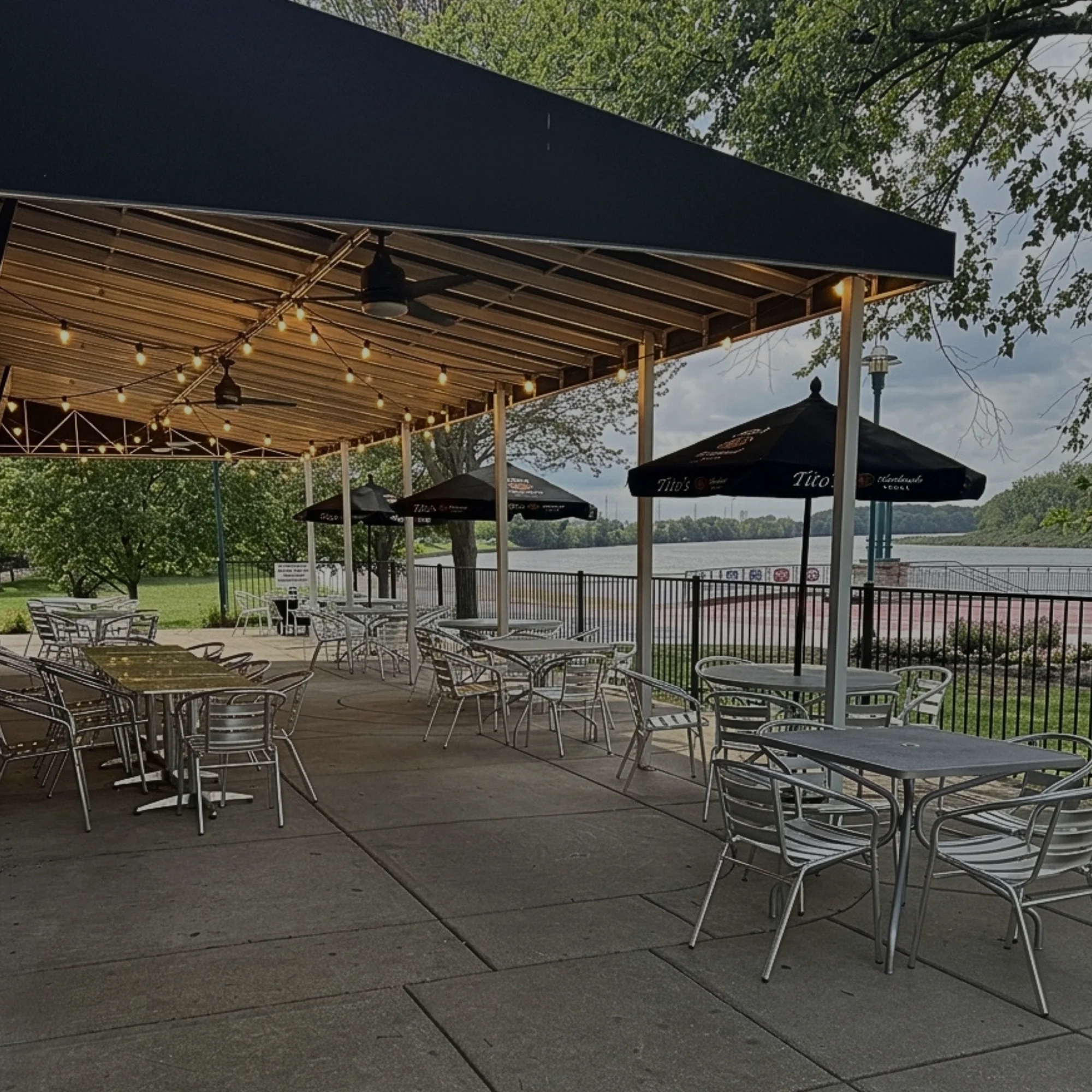 Riverfront patio at Bass Street in downtown Moline, IL with fire pits and views of the Mississippi River
