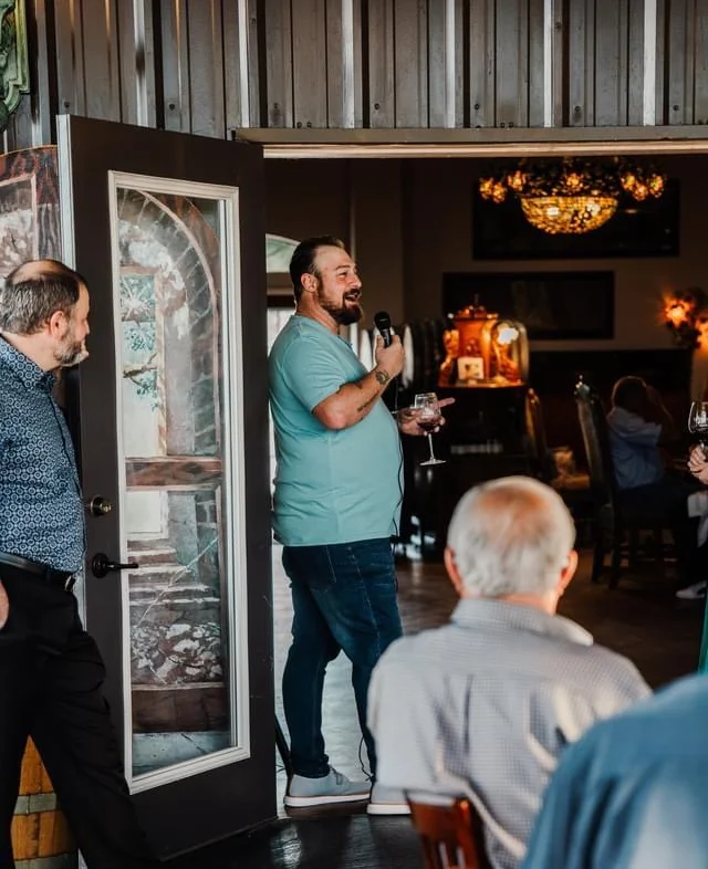 Speaker engaging guests in a cozy restaurant setting