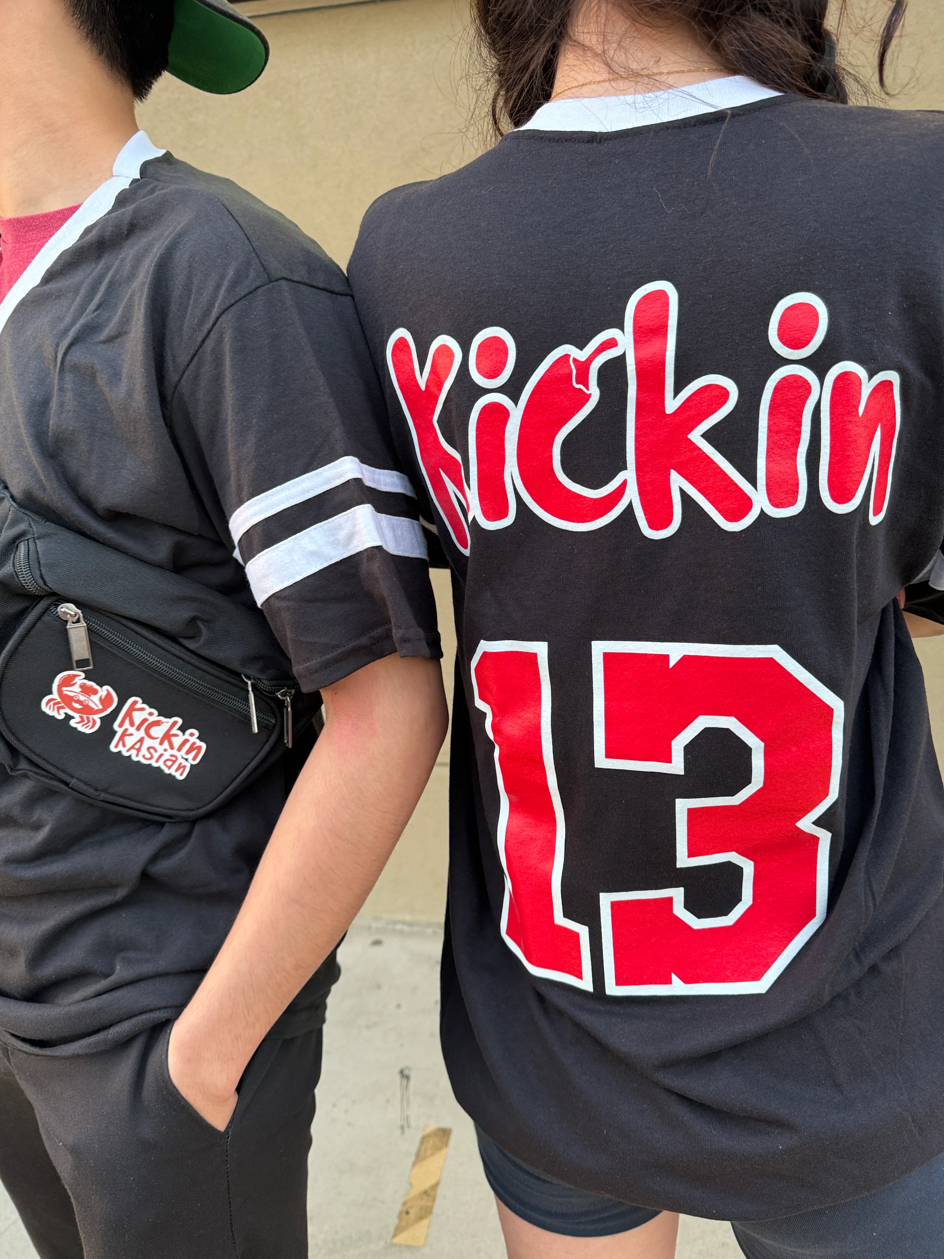 Casual streetwear featuring 'Kickin' 13' design on black shirts