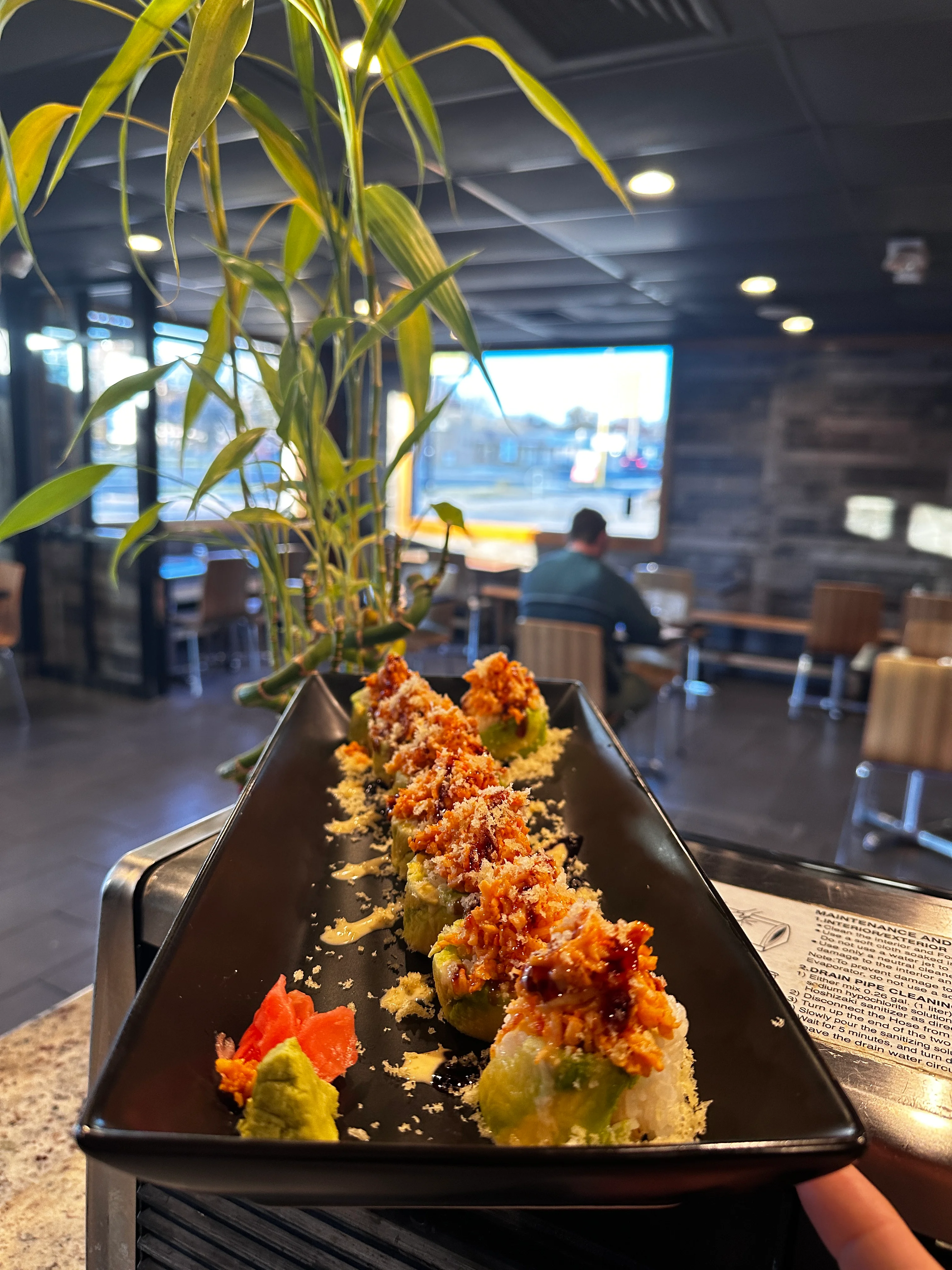 Crispy sushi rolls with avocado in a modern restaurant setting