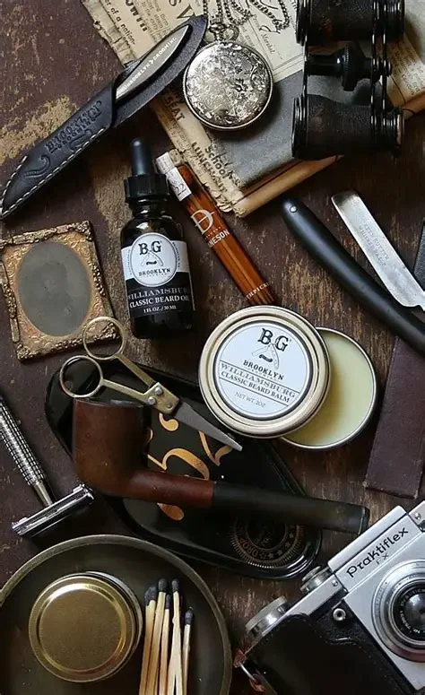 An arrangement of vintage items including a pipe, tools, a camera, and grooming products on a wooden surface.