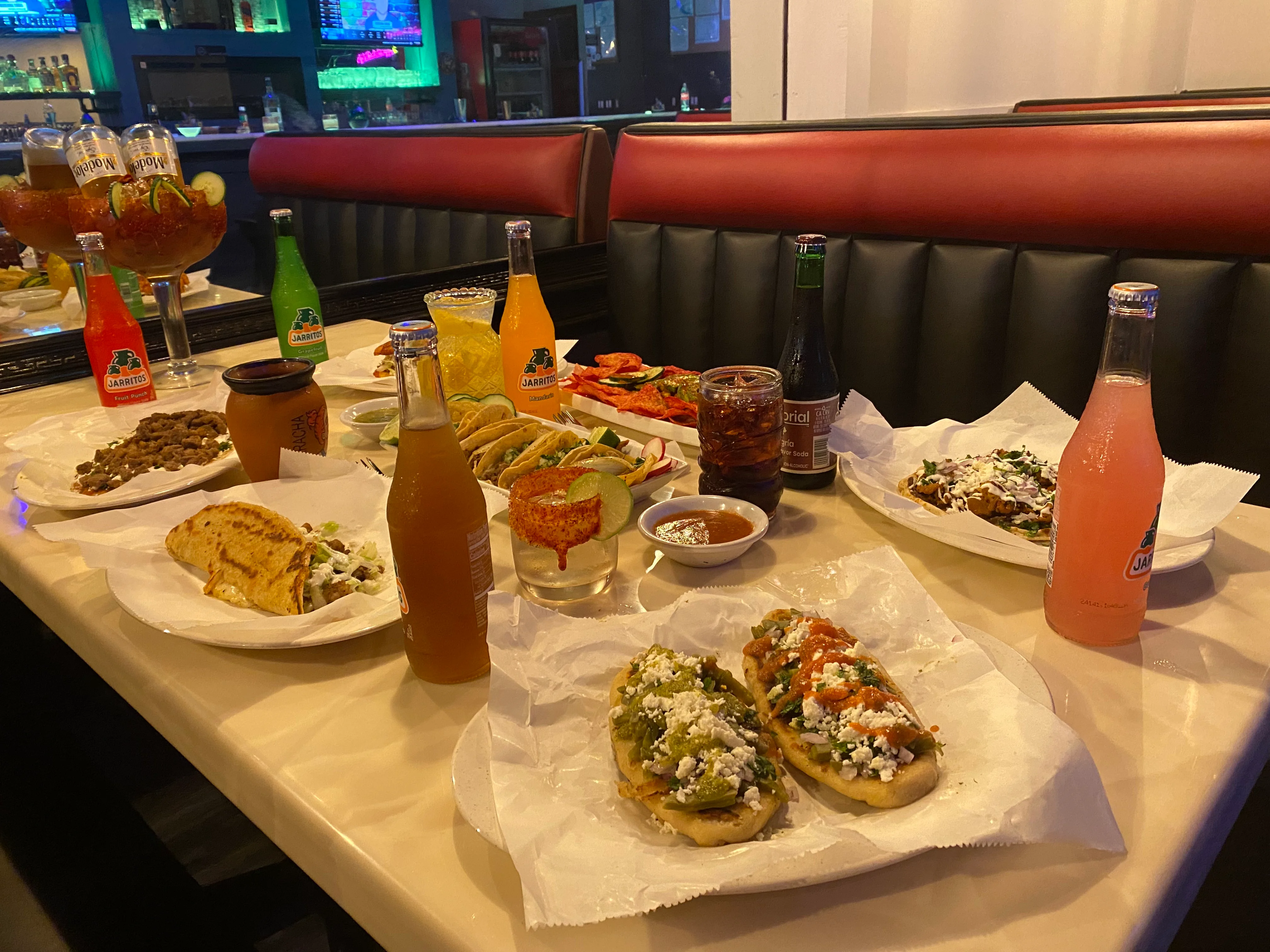 Colorful Mexican feast with tacos, drinks, and traditional dishes