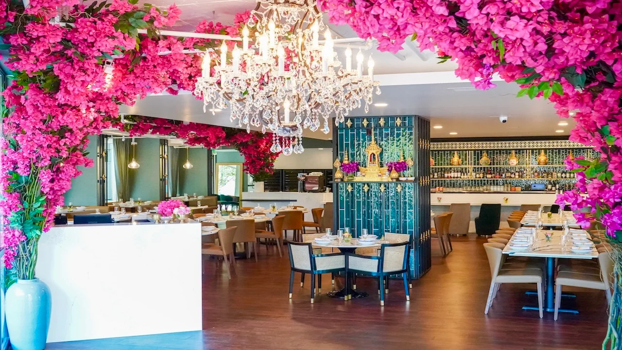 Elegant restaurant interior adorned with vibrant pink flowers