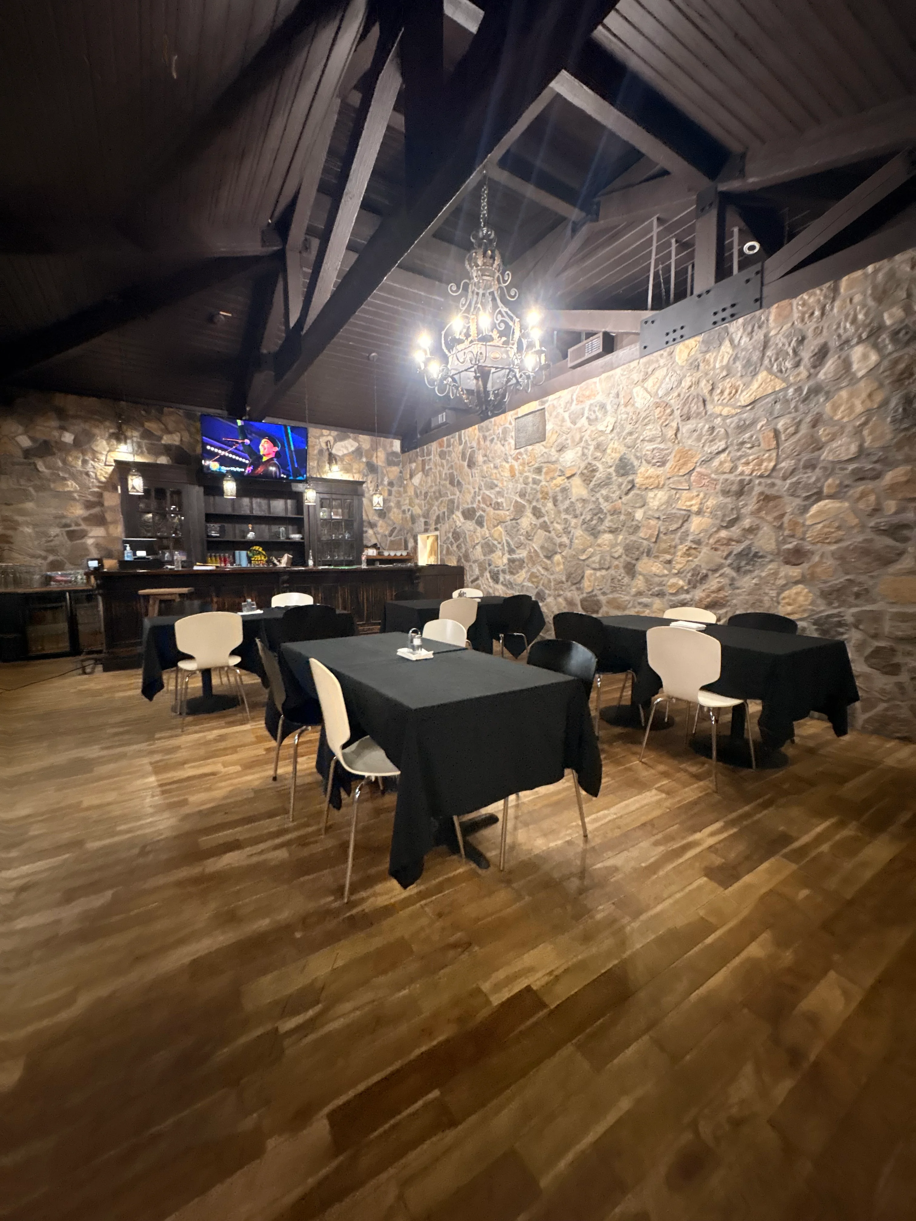 Elegant restaurant interior with wooden floors and stone walls