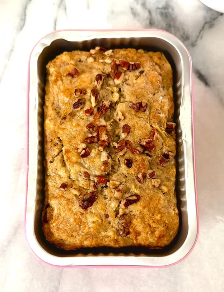 Freshly baked banana bread topped with pecans
