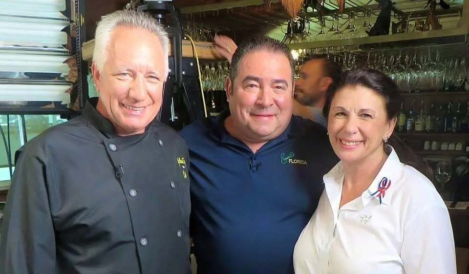 Chefs and restaurateurs posing in a vibrant restaurant setting