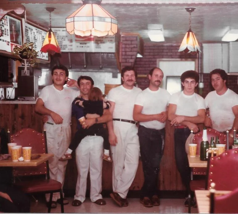 Vintage restaurant staff posing in a cozy diner setting