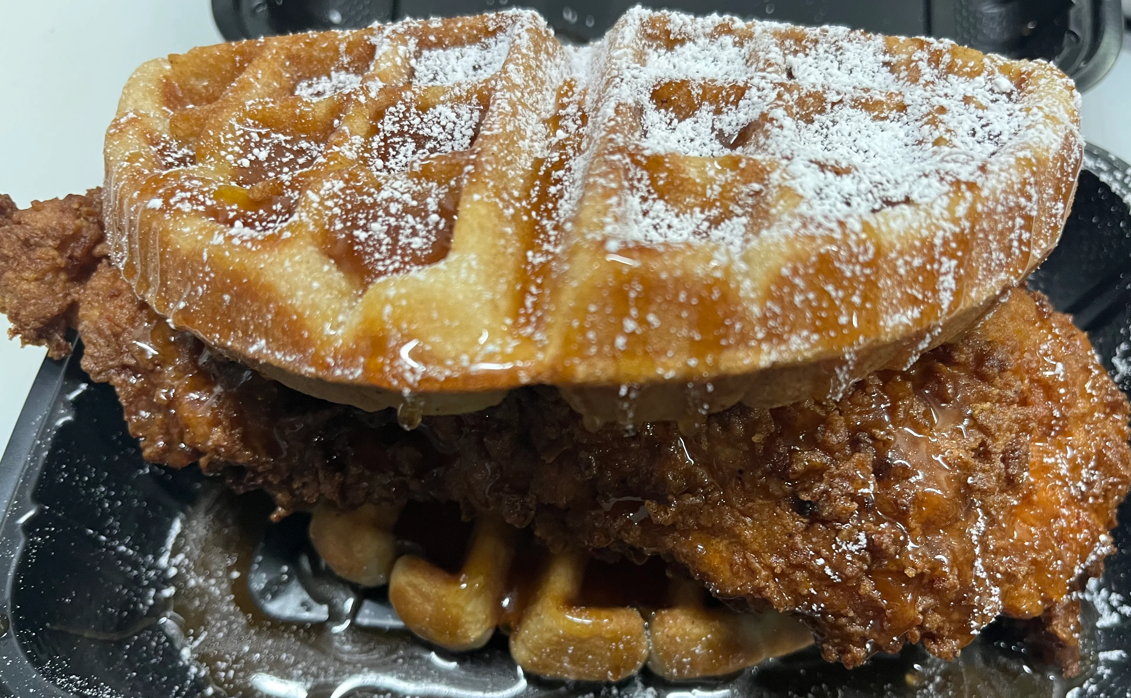 Southern chicken and waffles drizzled with syrup