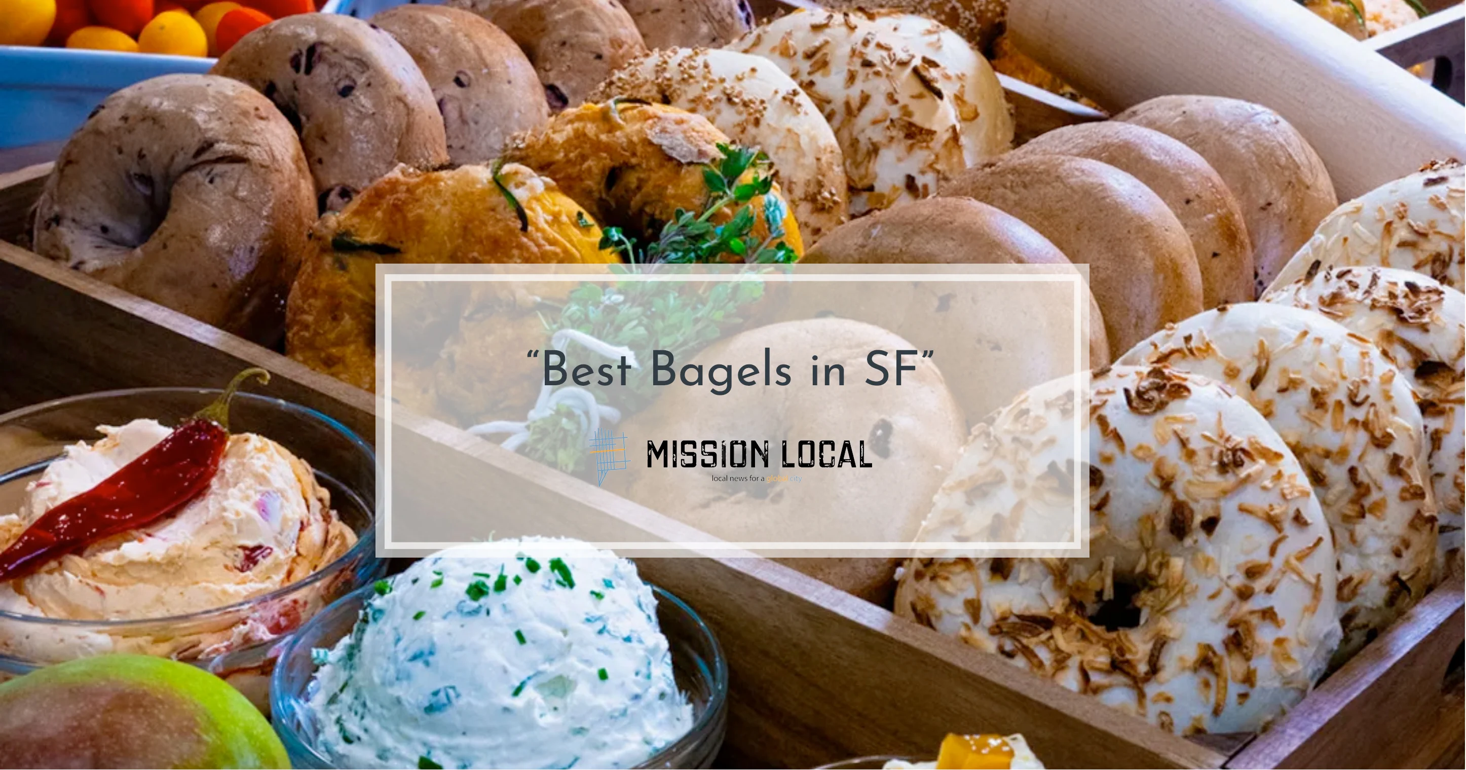 Artisan bagels displayed in a wooden tray