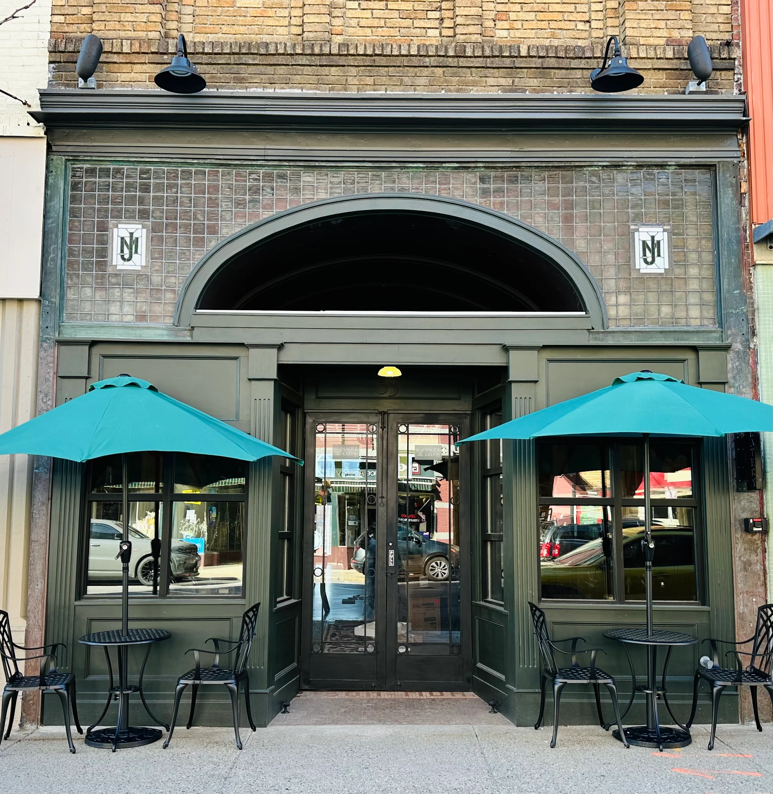 Charming restaurant entrance with teal umbrellas and vintage architecture