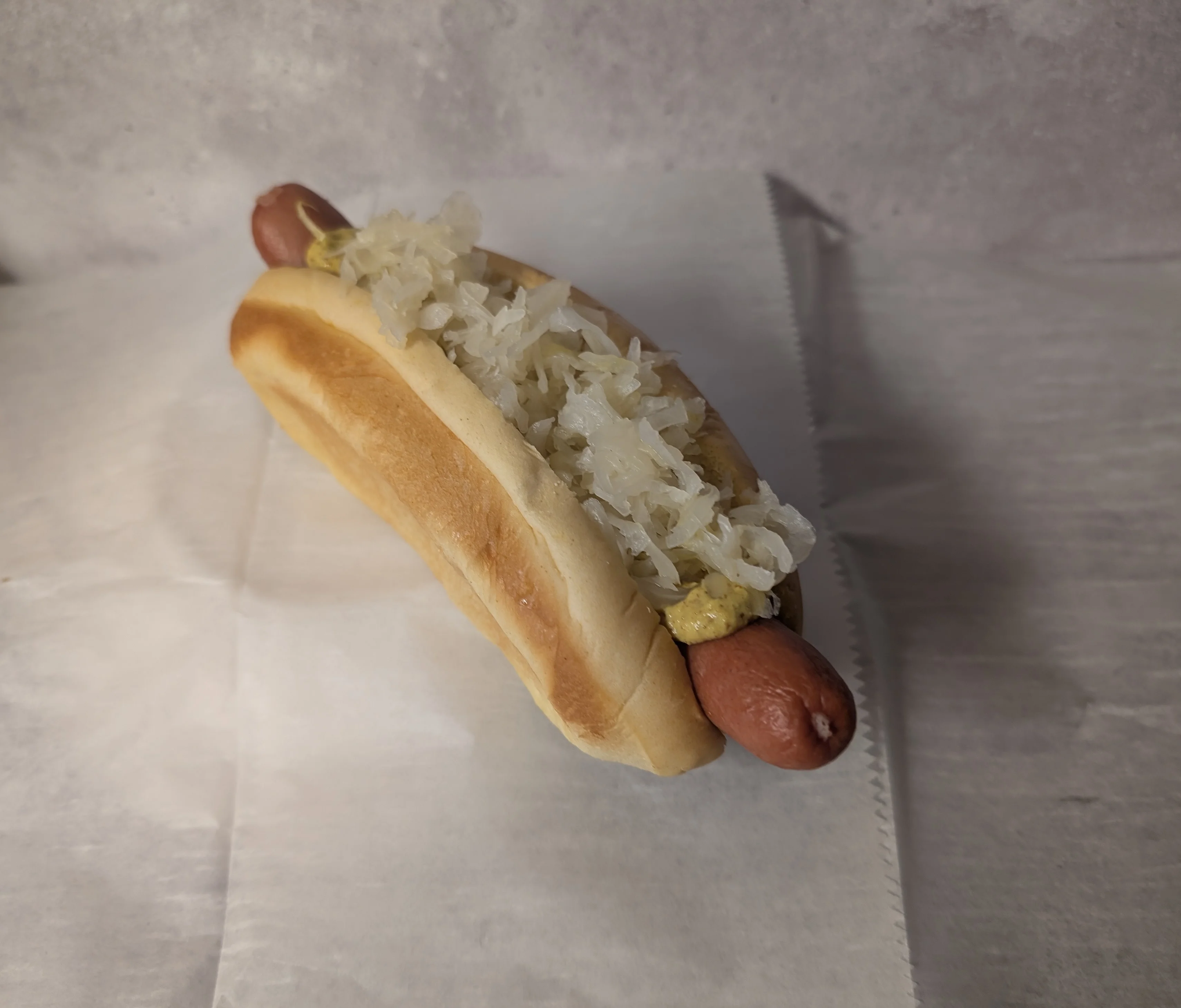Classic American hot dog with sauerkraut and mustard