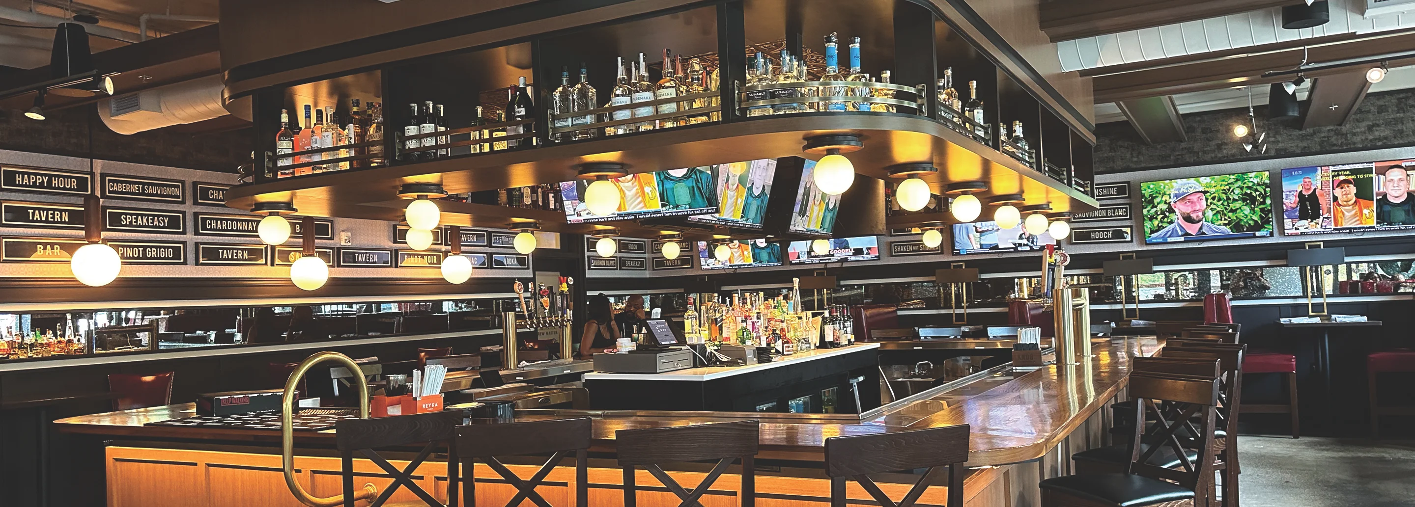 Modern bar interior with vibrant lighting and a wide selection of spirits
