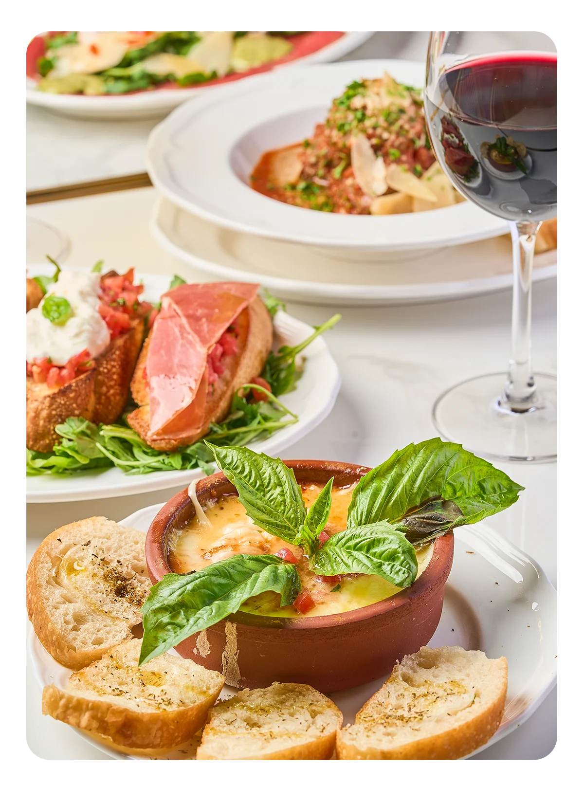 Italian baked cheese dish with fresh basil and crusty bread