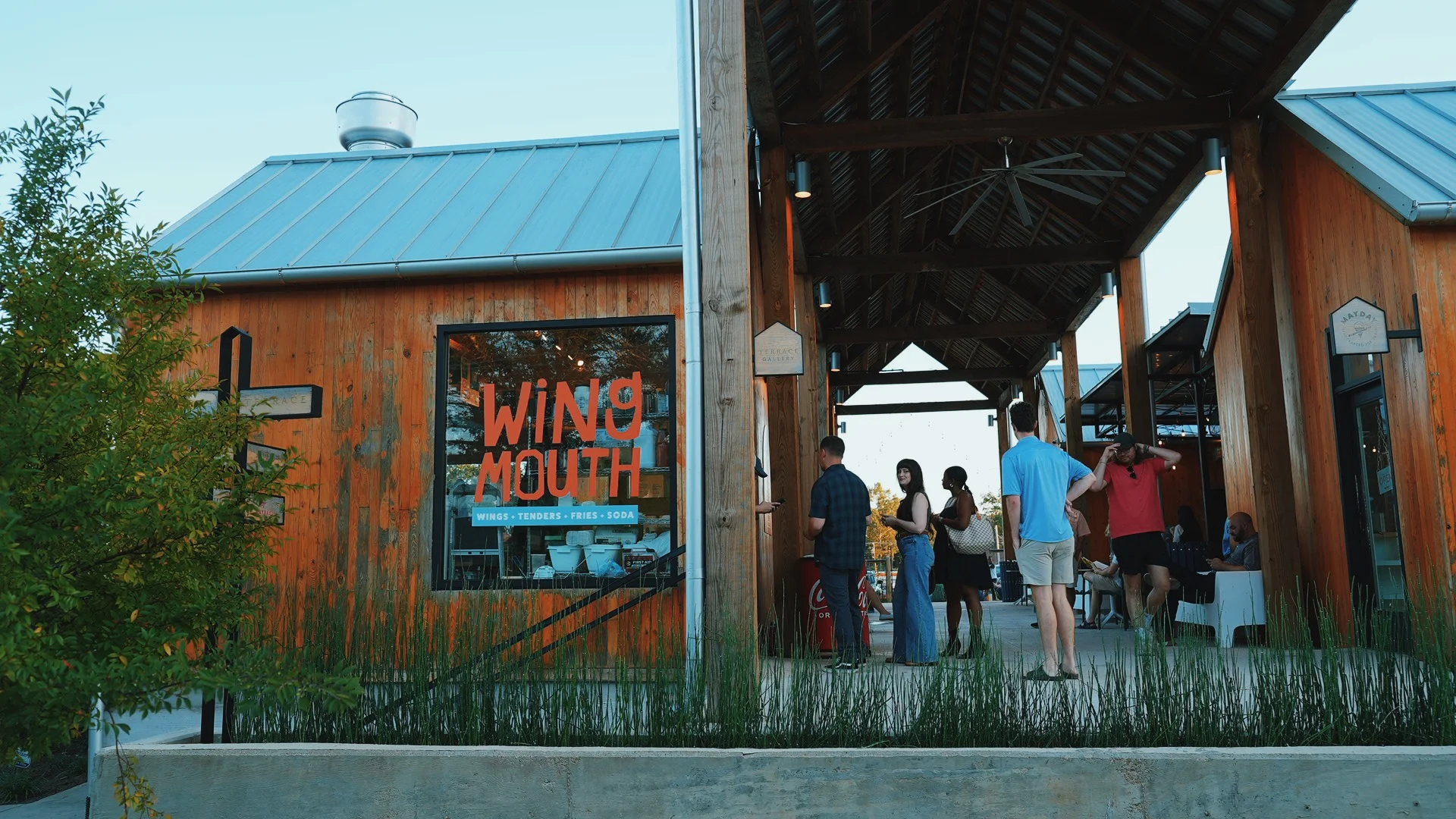 Exterior view of Wing Mouth restaurant with vibrant signage