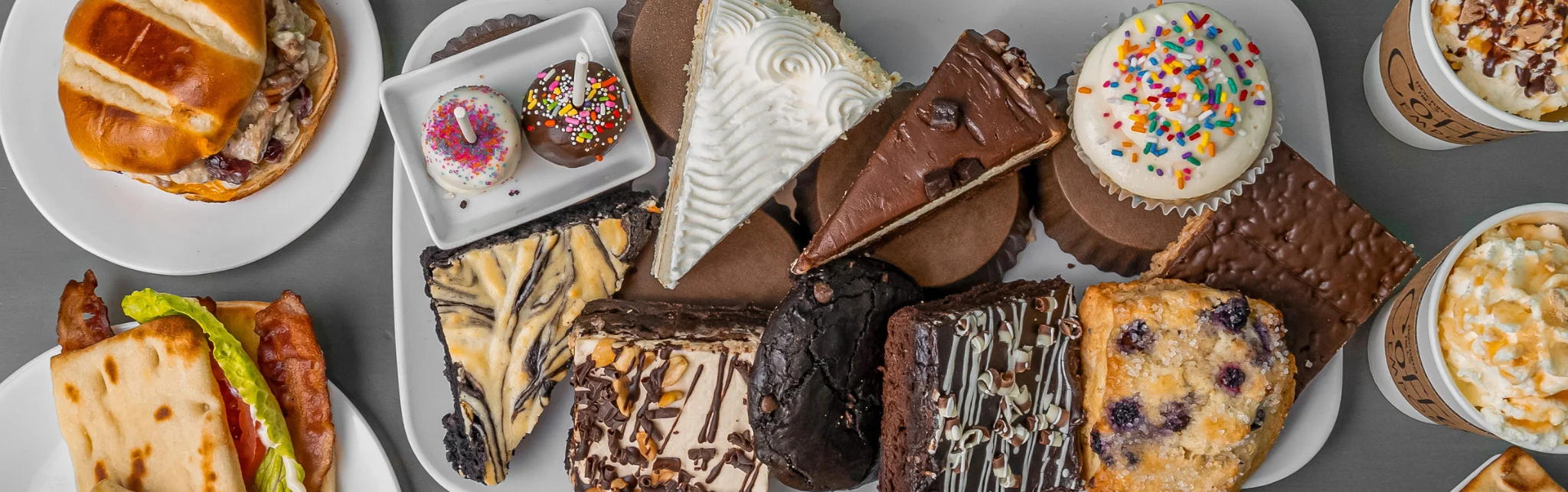 Assorted desserts including cakes and cupcakes on a platter