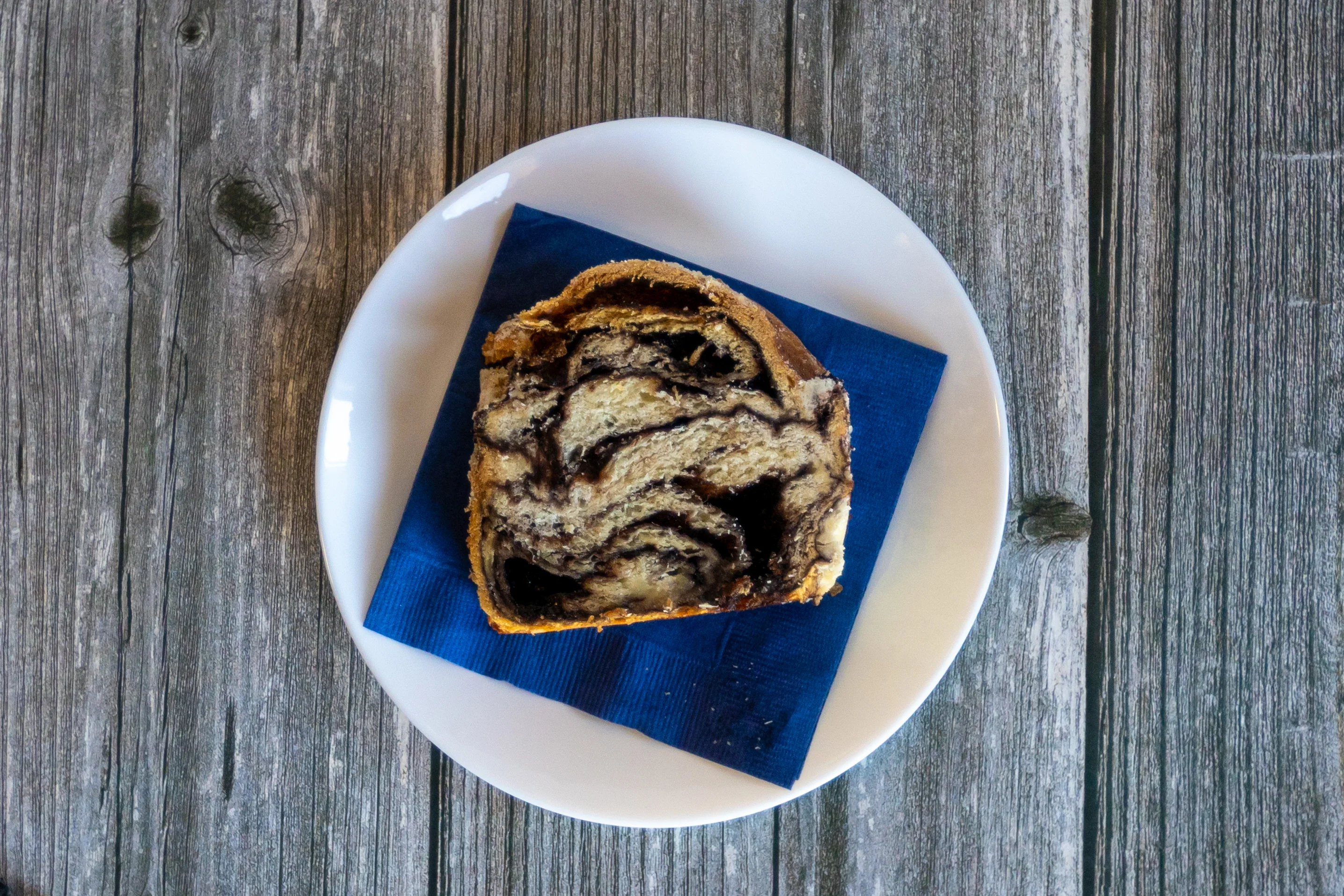 Chocolate babka slice on a blue napkin