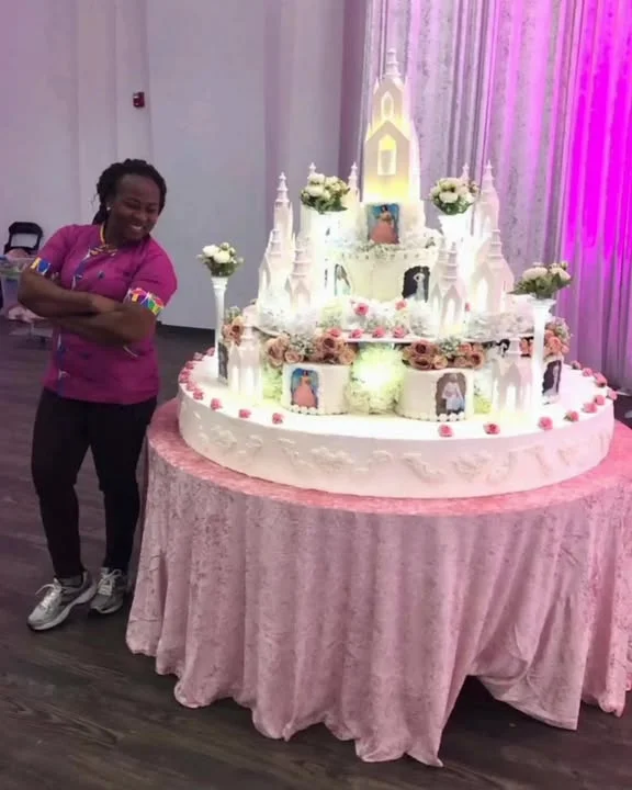Elaborate cake design resembling a fairytale castle with floral accents