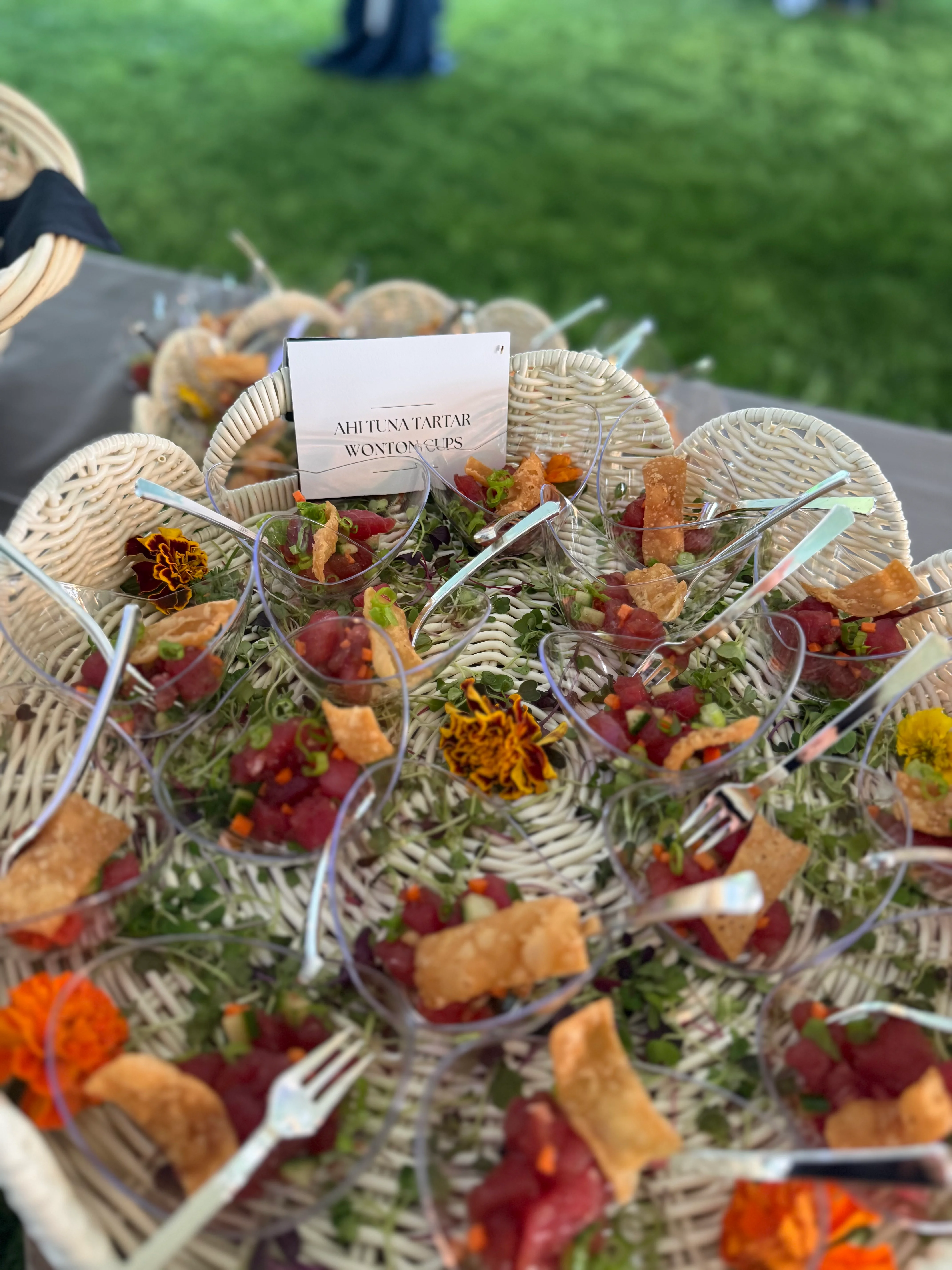 Ahi tuna tartar served in wonton cups with garnishes.