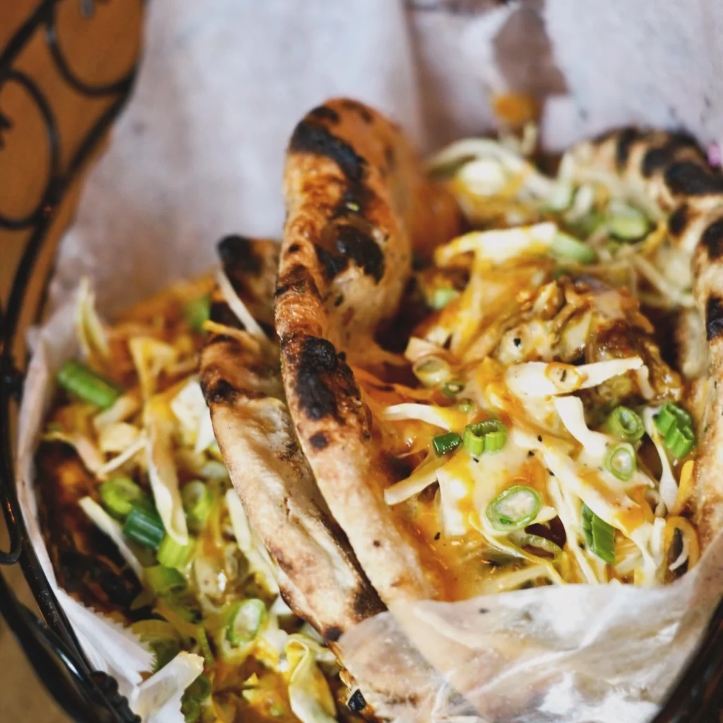 Savory Indian naan topped with cheese and fresh vegetables