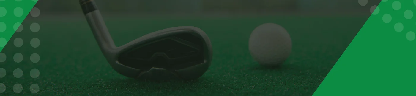 Golf club and ball on green turf