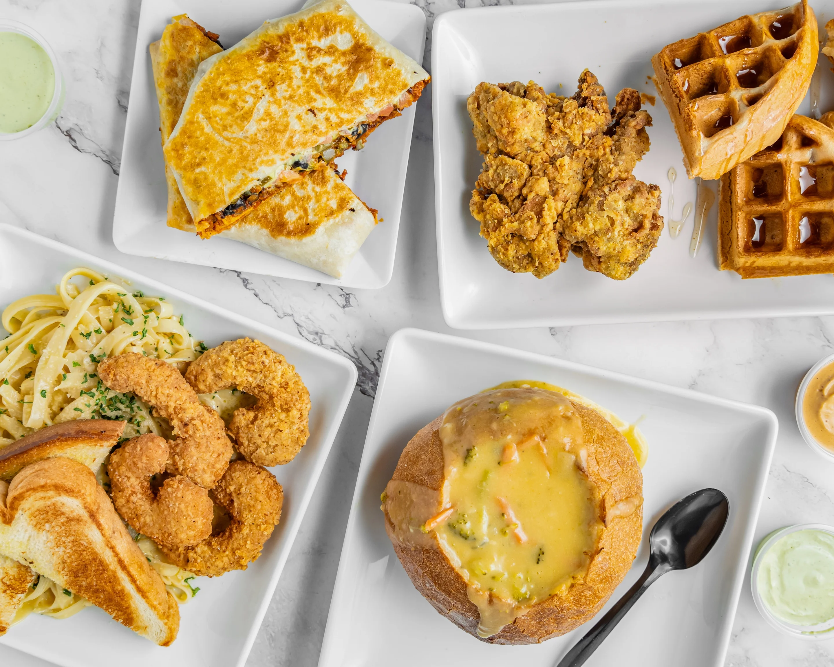 Southern fried chicken and waffles with shrimp fettuccine and chowder bread bowl