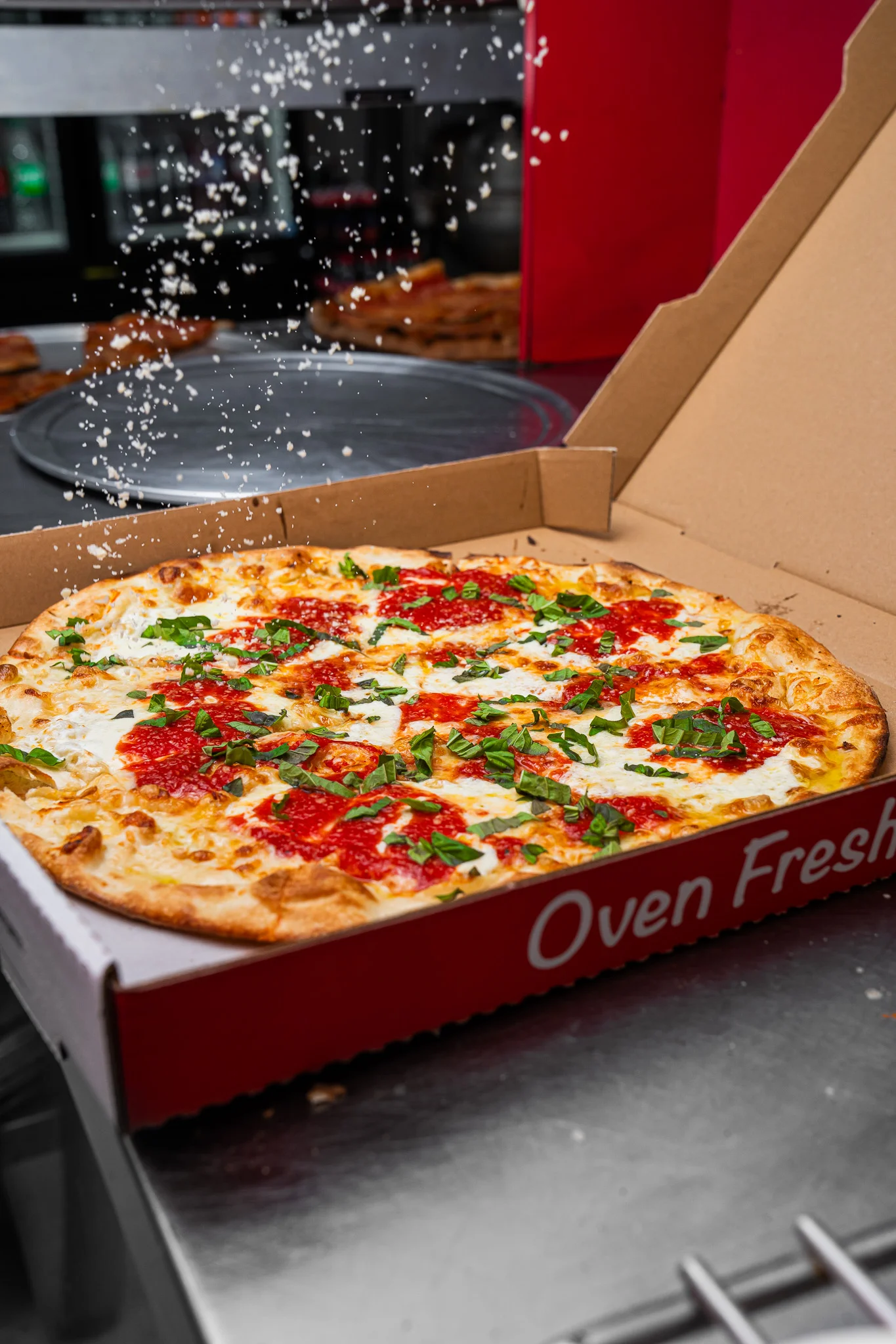 Fresh Margherita pizza in a takeout box