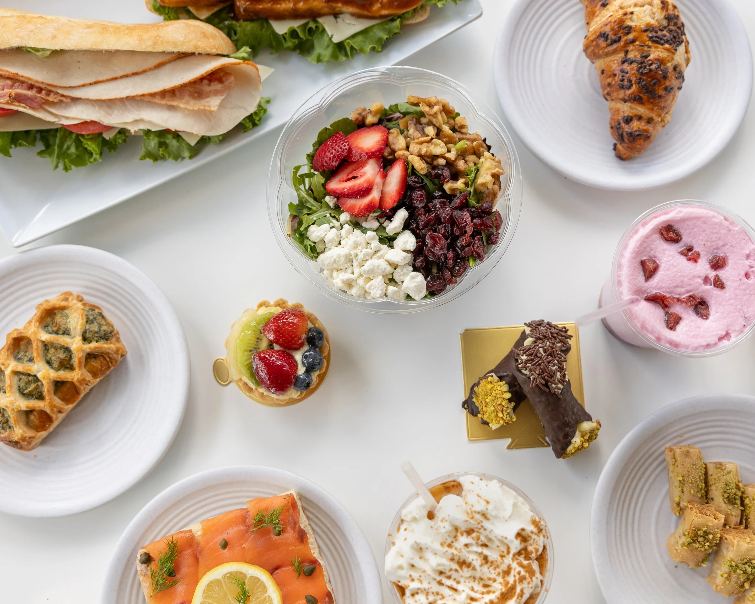 A variety of delicious dishes including sandwiches, salads, and desserts.