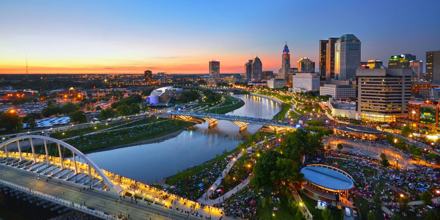 Panoramic view of a vibrant city skyline at sunset