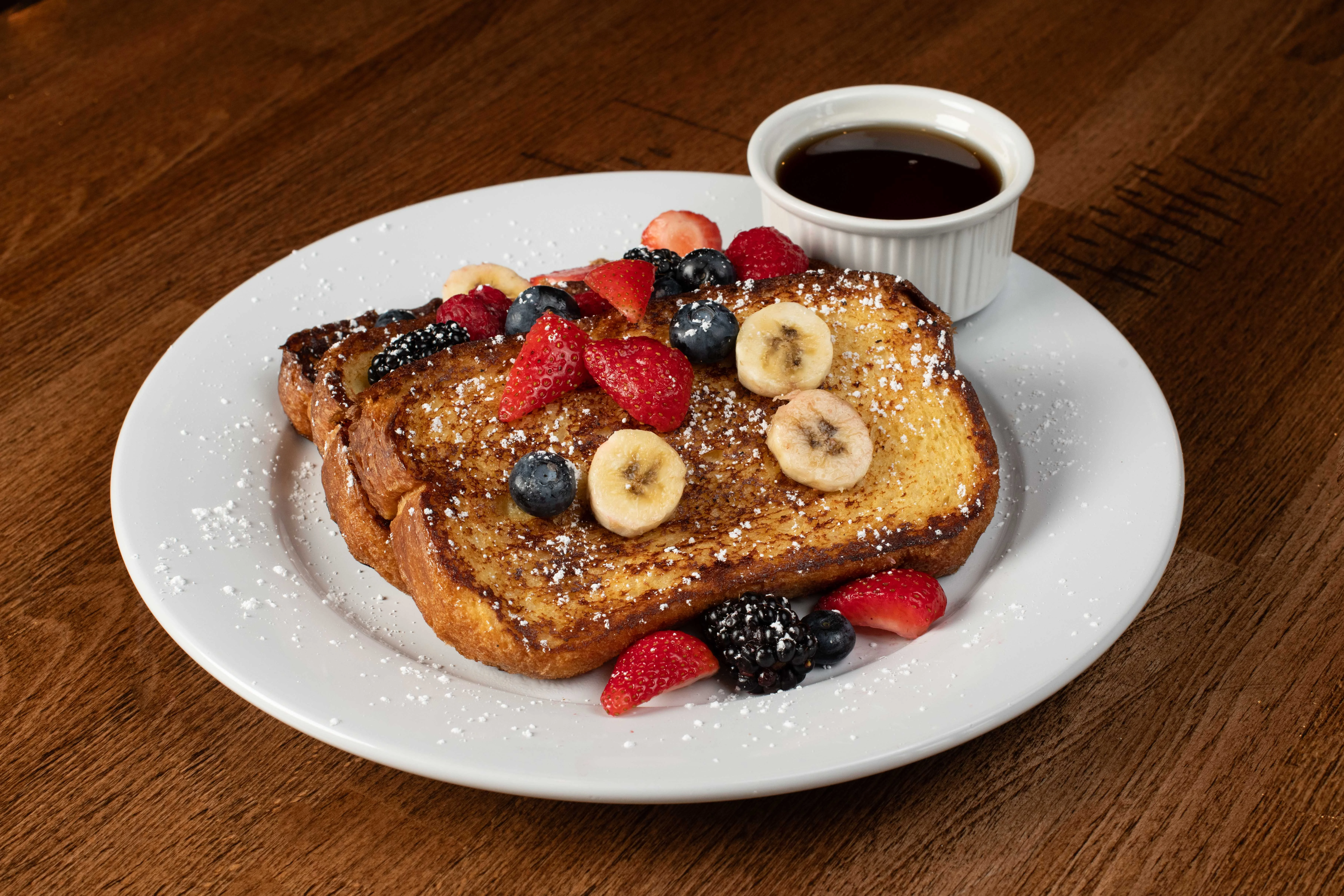 French toast topped with fresh berries and syrup