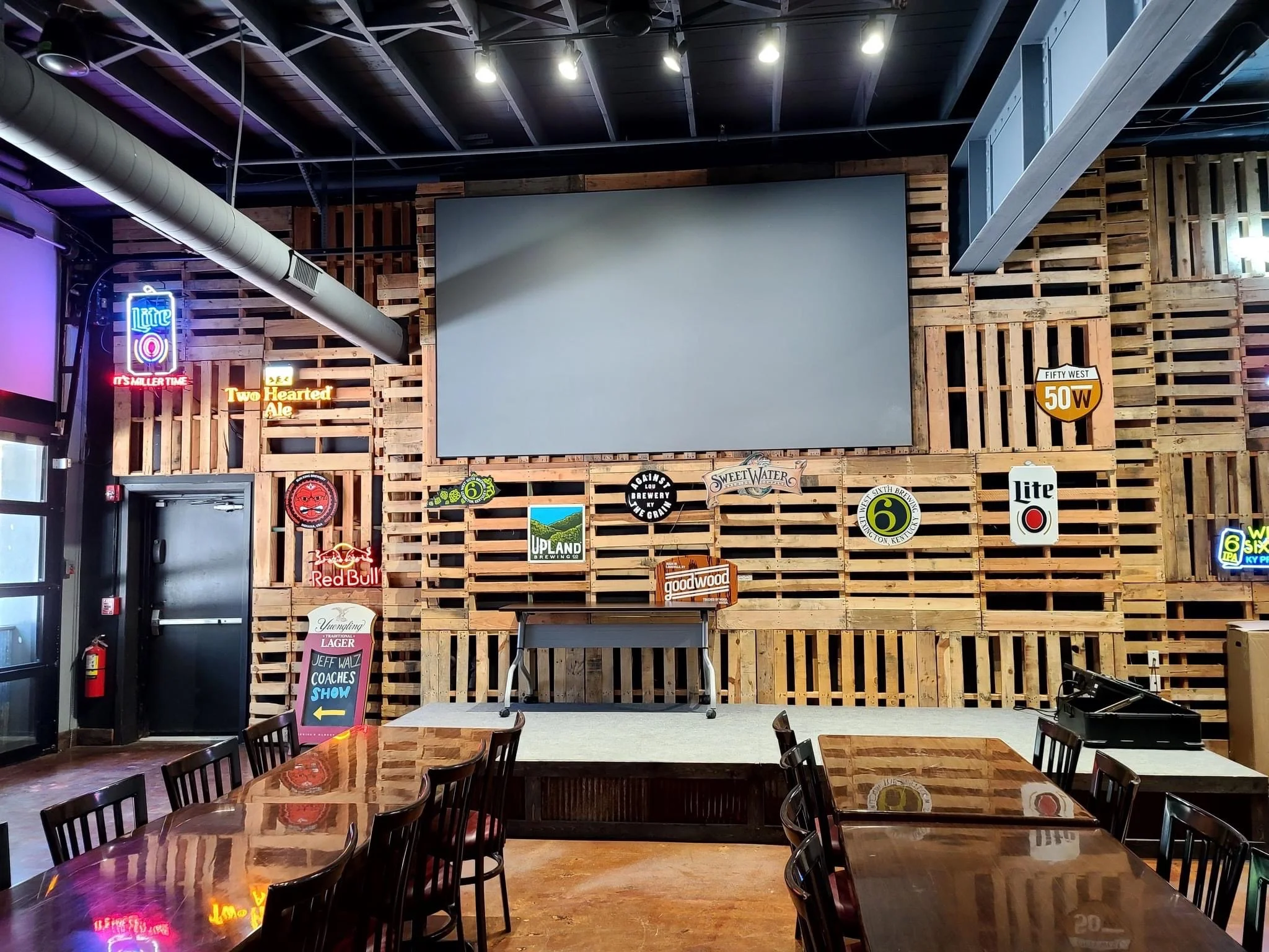 Private event space with stage and bar at Parlour Pizza in Downtown Louisville, KY