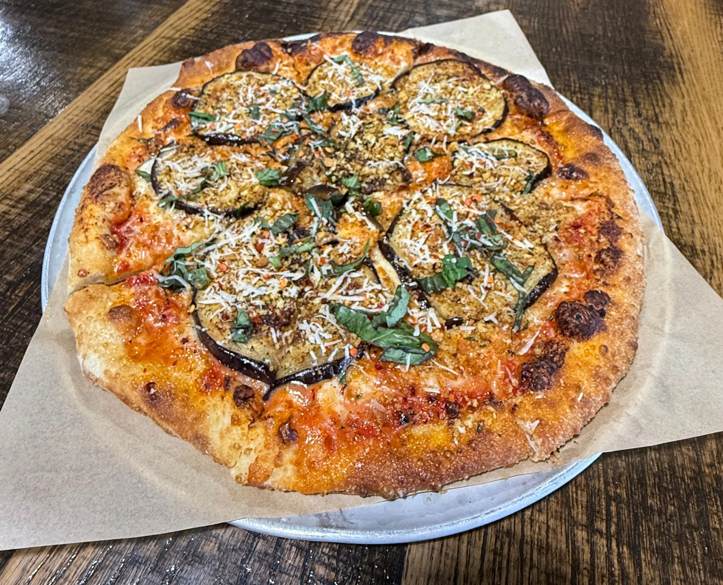 Eggplant pizza with crispy toppings and fresh basil