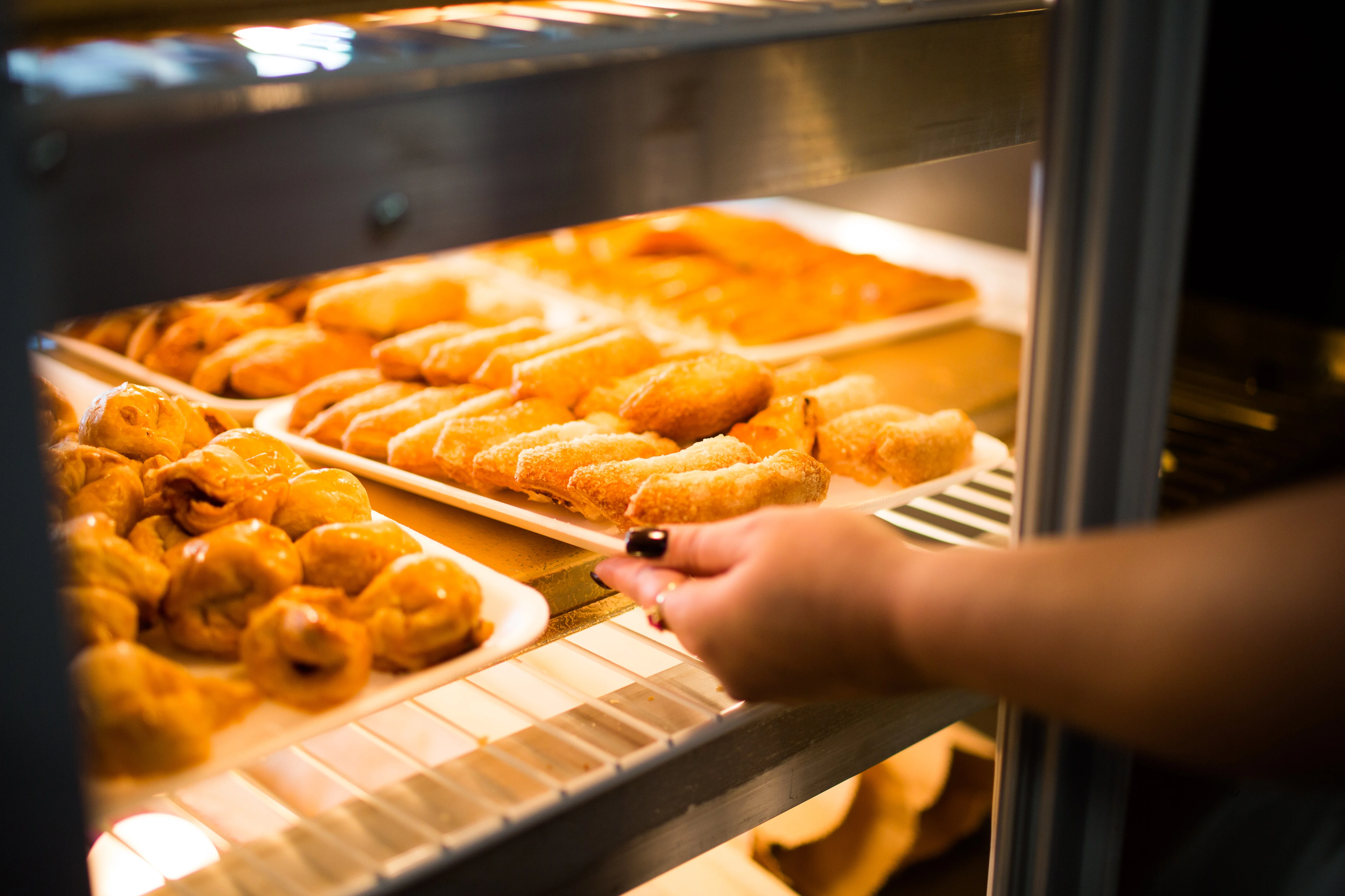 Assorted pastries in a display case at a bakery