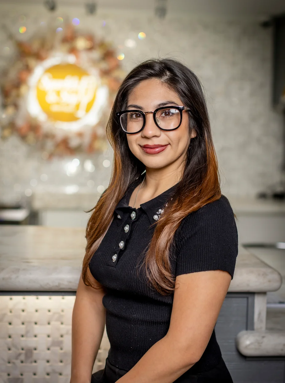 Restaurant staff member posing at a modern bar counter