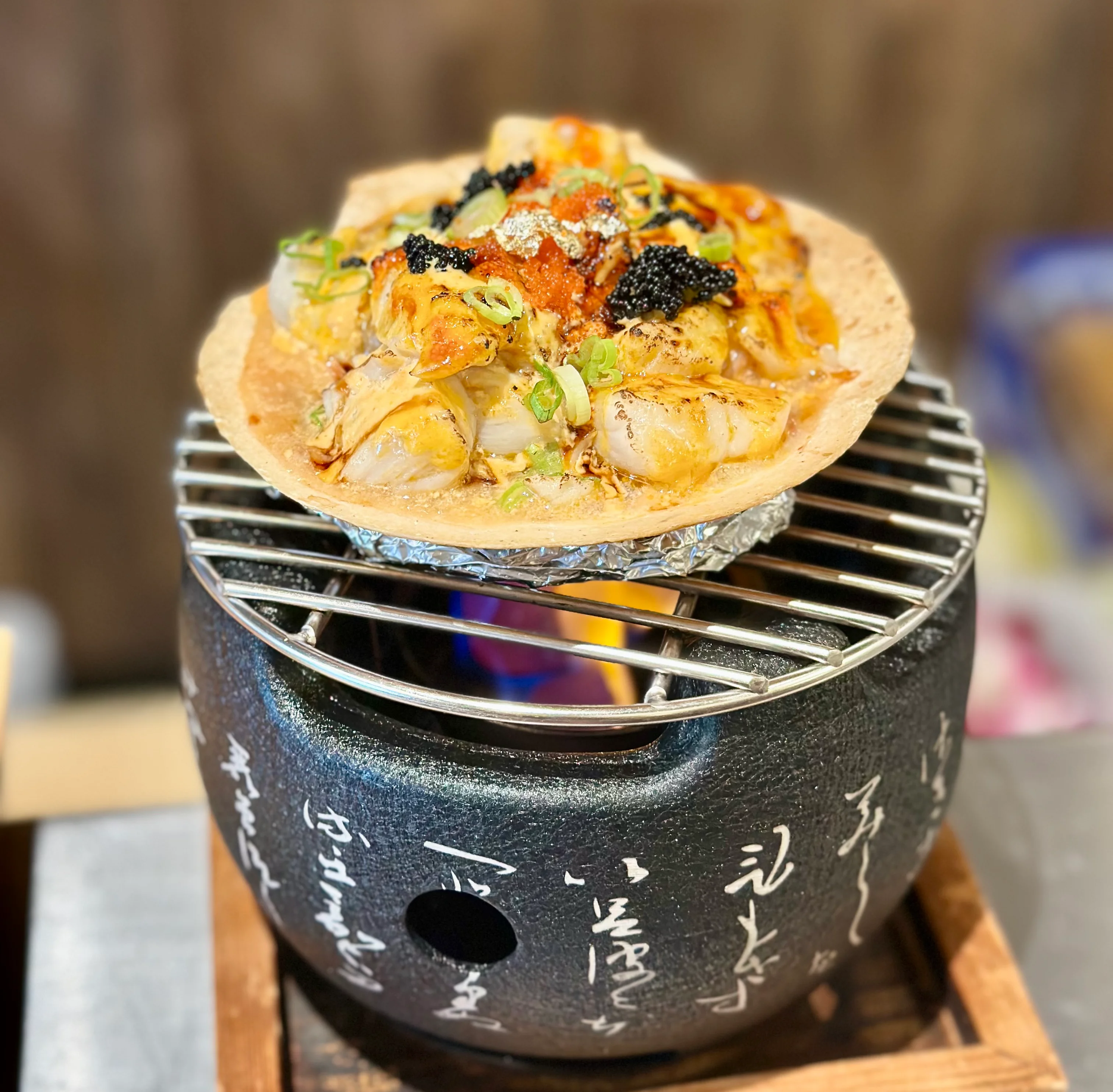 Japanese okonomiyaki served on a grill