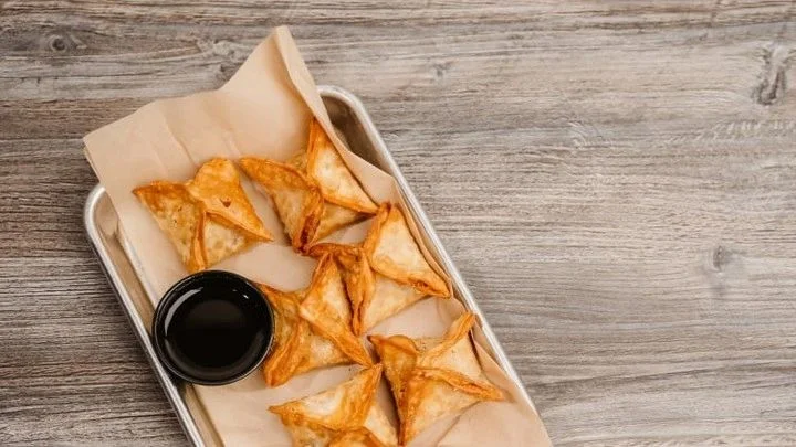 Crispy Indian samosas served with dipping sauce
