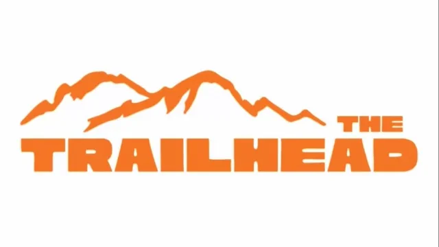 A logo featuring the word 'Trailhead' with stylized mountain peaks above it in orange.