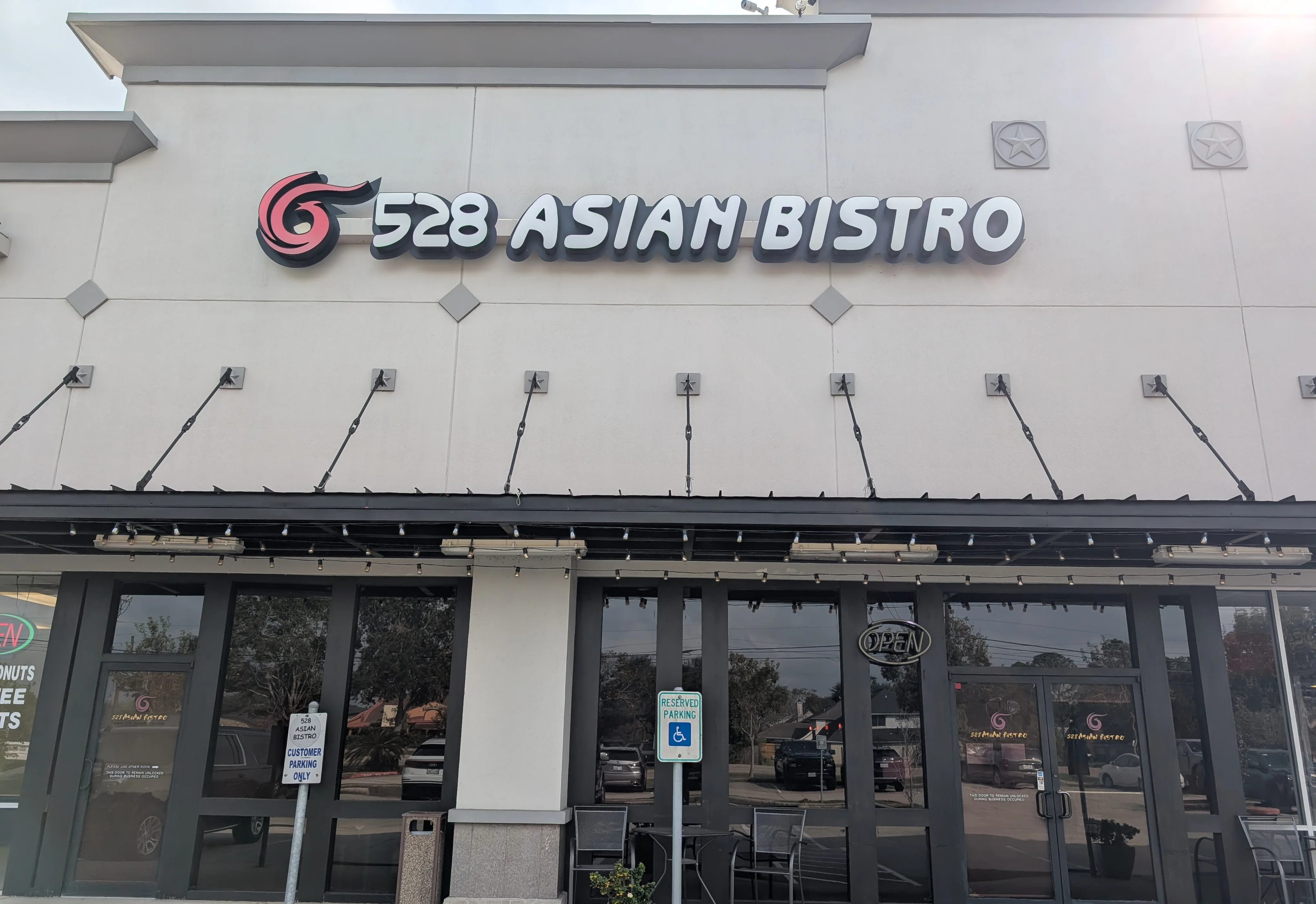Exterior view of 528 Asian Bistro restaurant with open sign