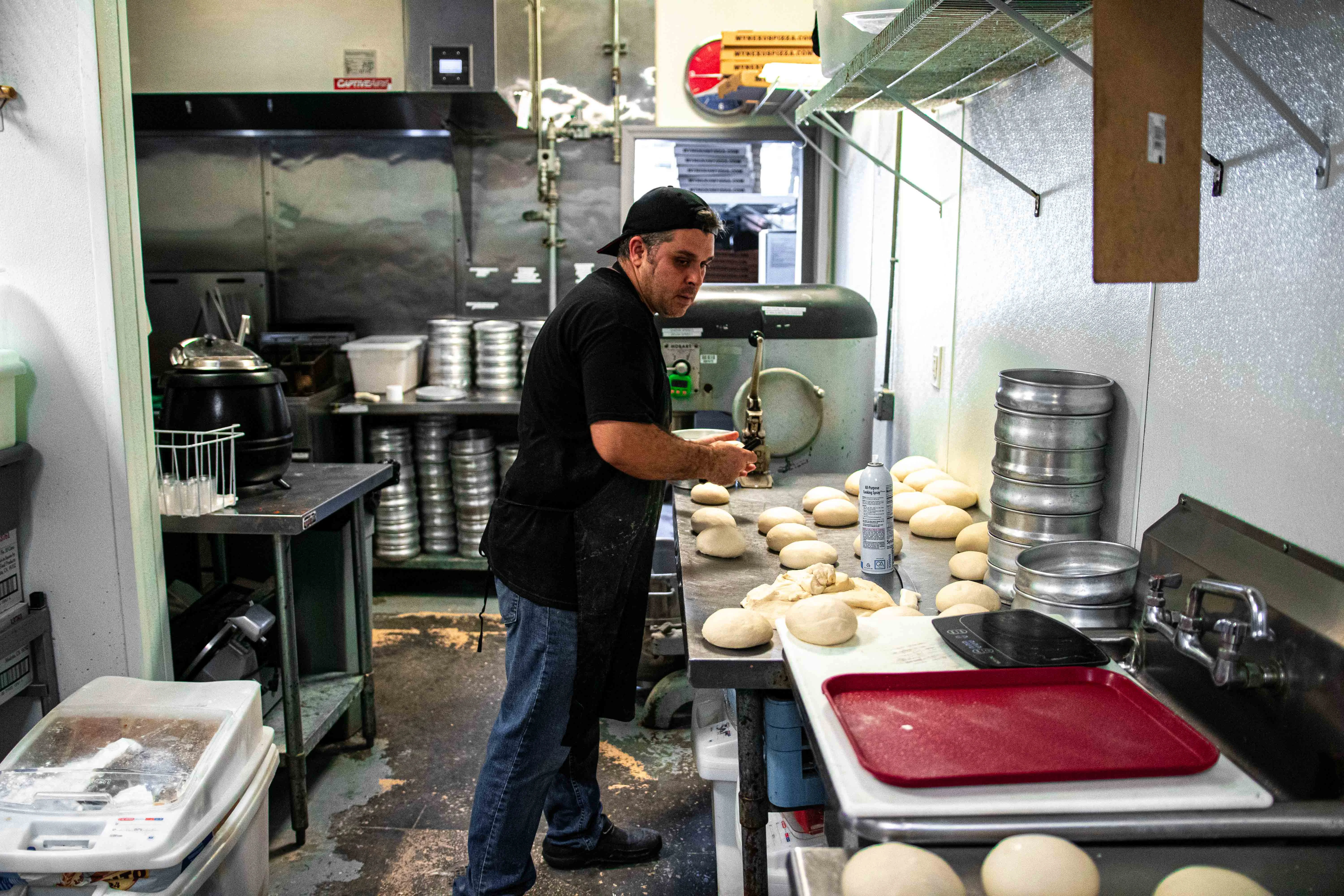 Baker preparing dough in a commercial kitchen