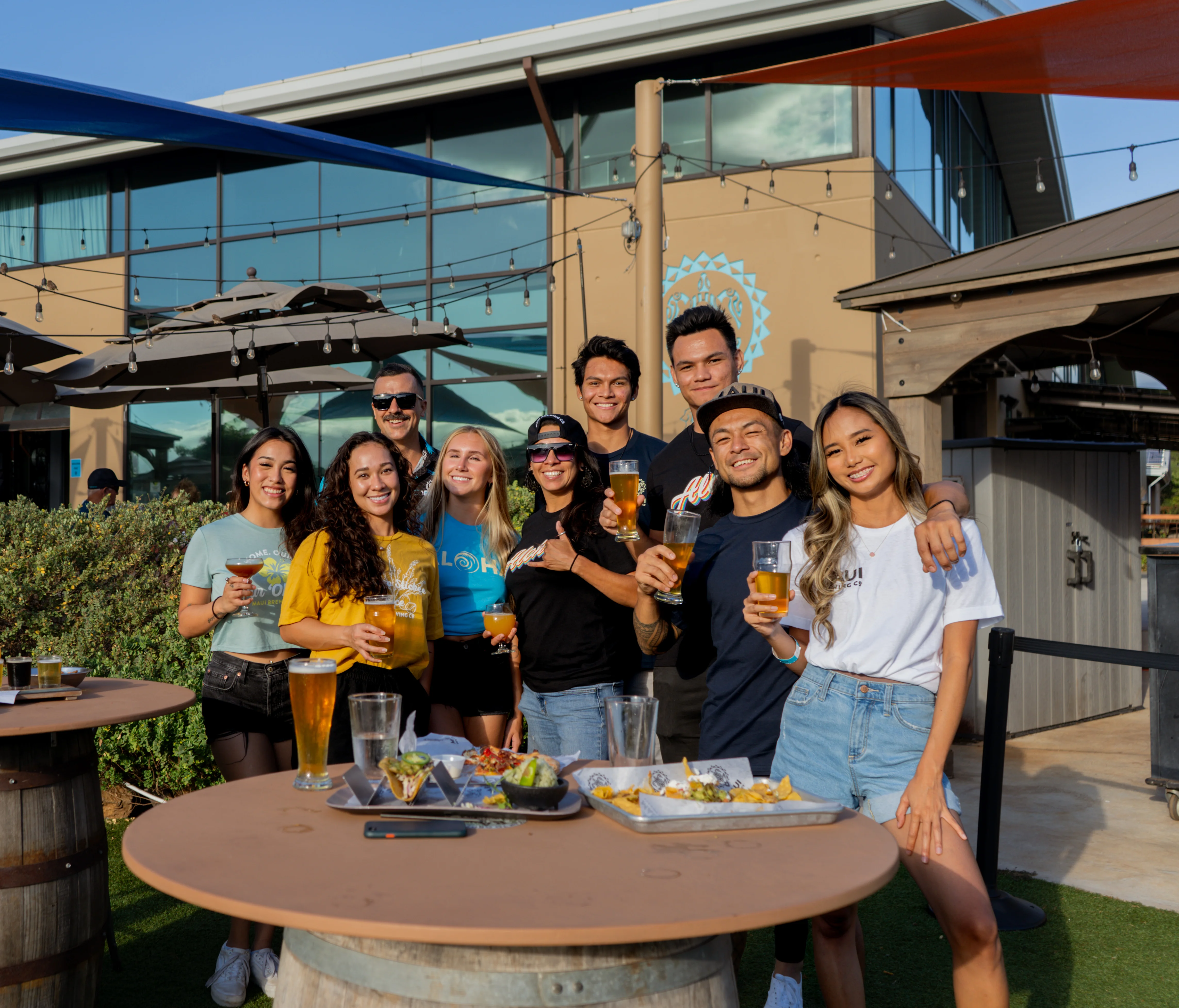 Group of friends enjoying drinks at a vibrant outdoor restaurant