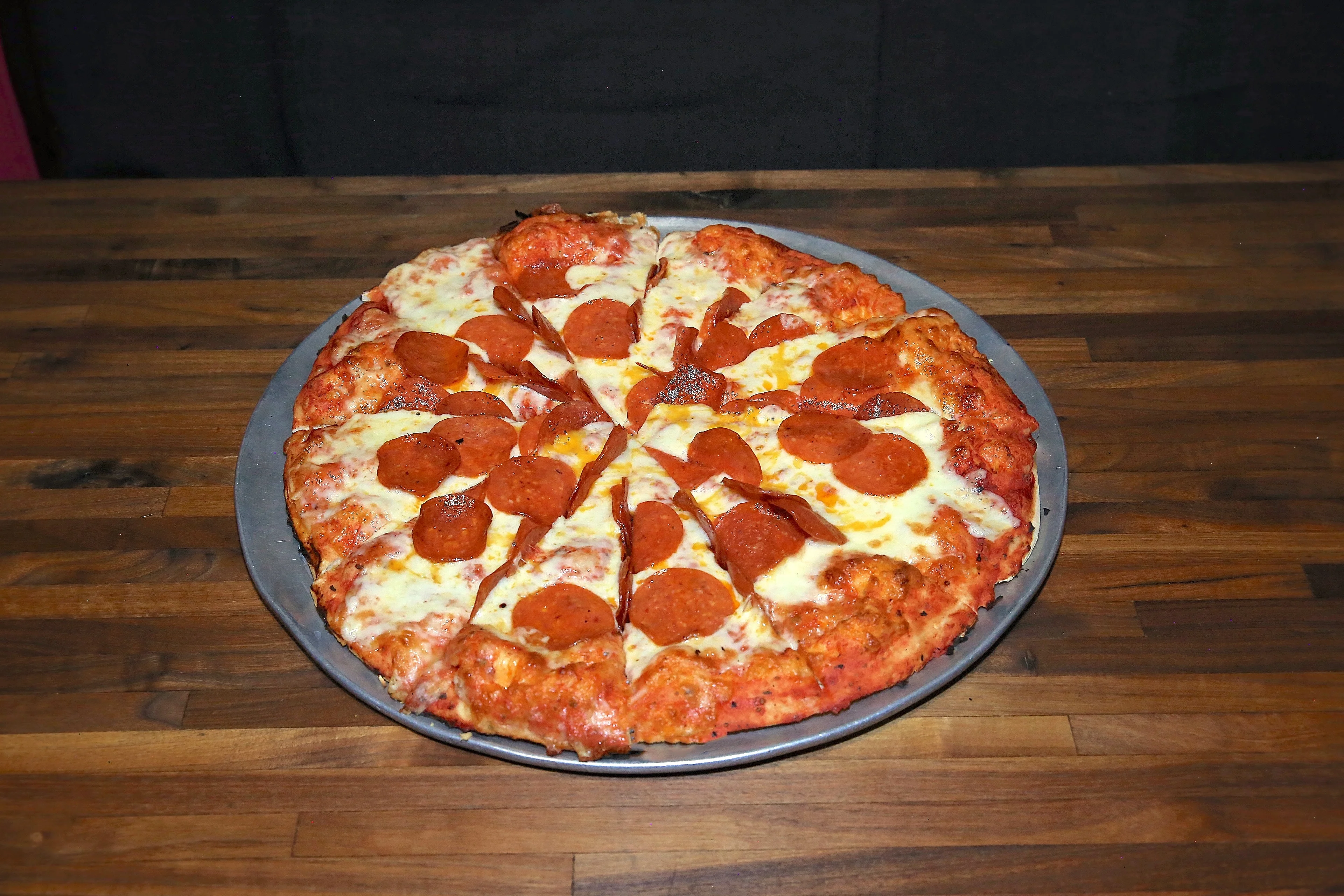 Classic pepperoni pizza on a metal tray
