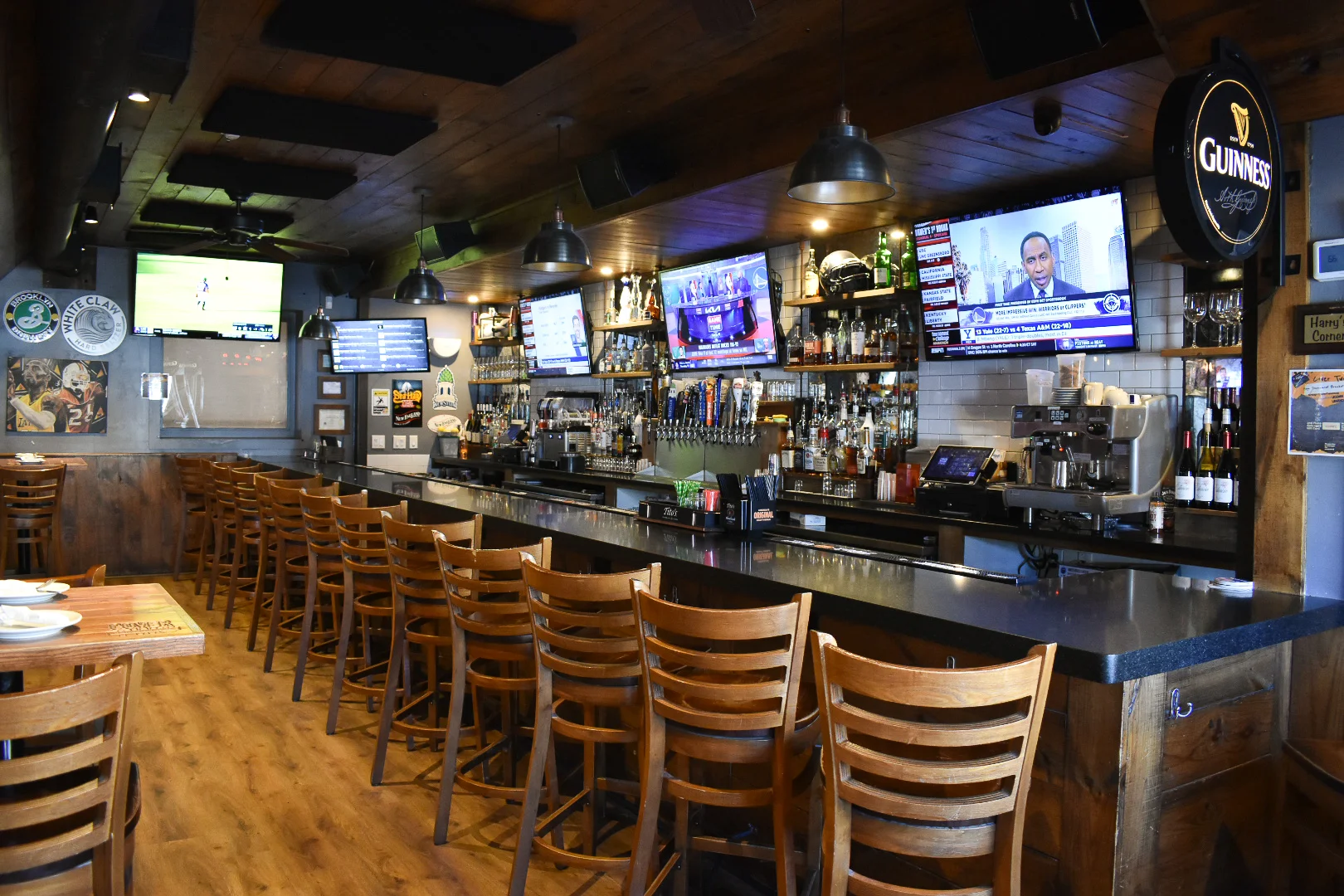 Cozy bar interior with wooden decor and multiple TVs
