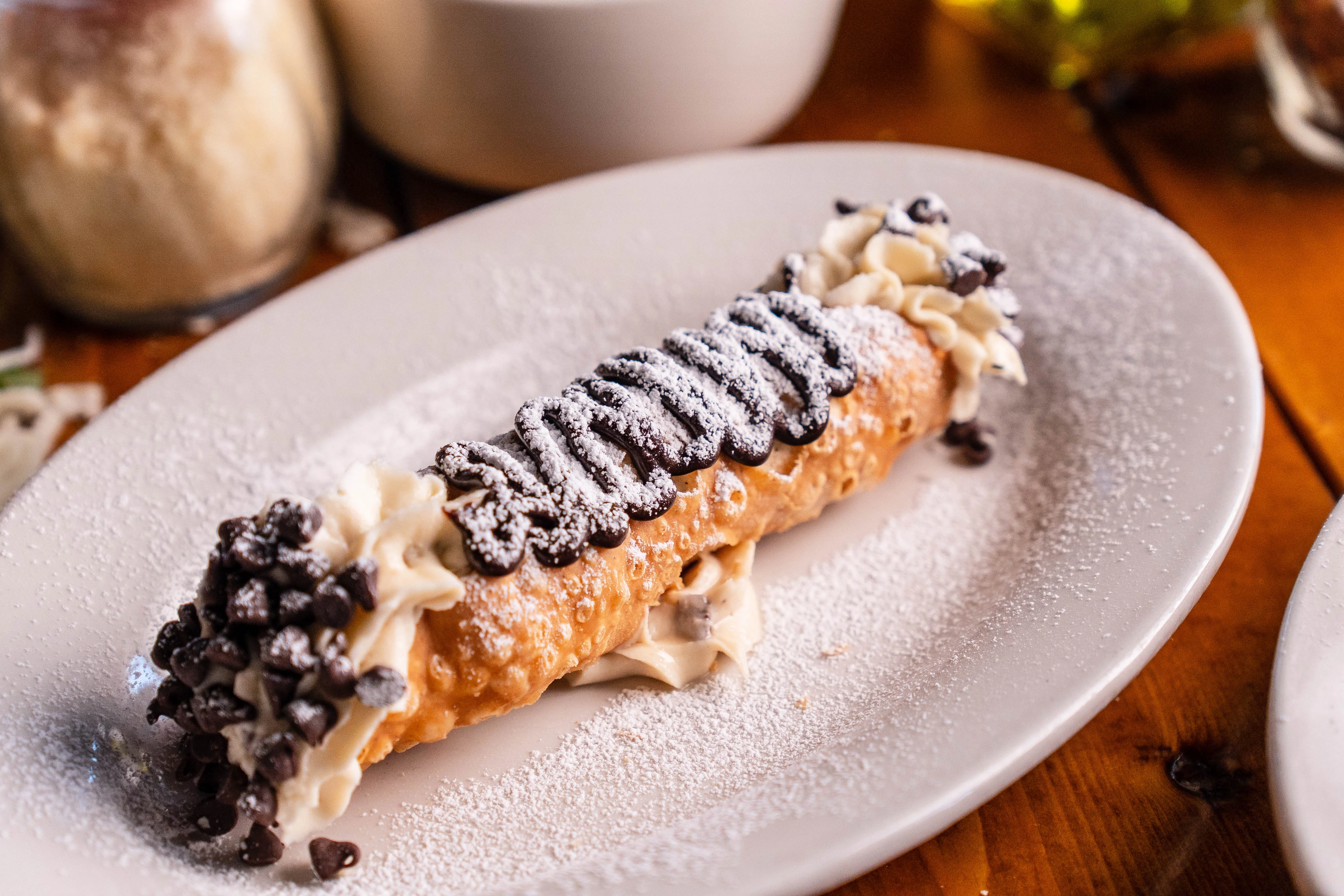 Classic Italian cannoli with chocolate chips and whipped cream