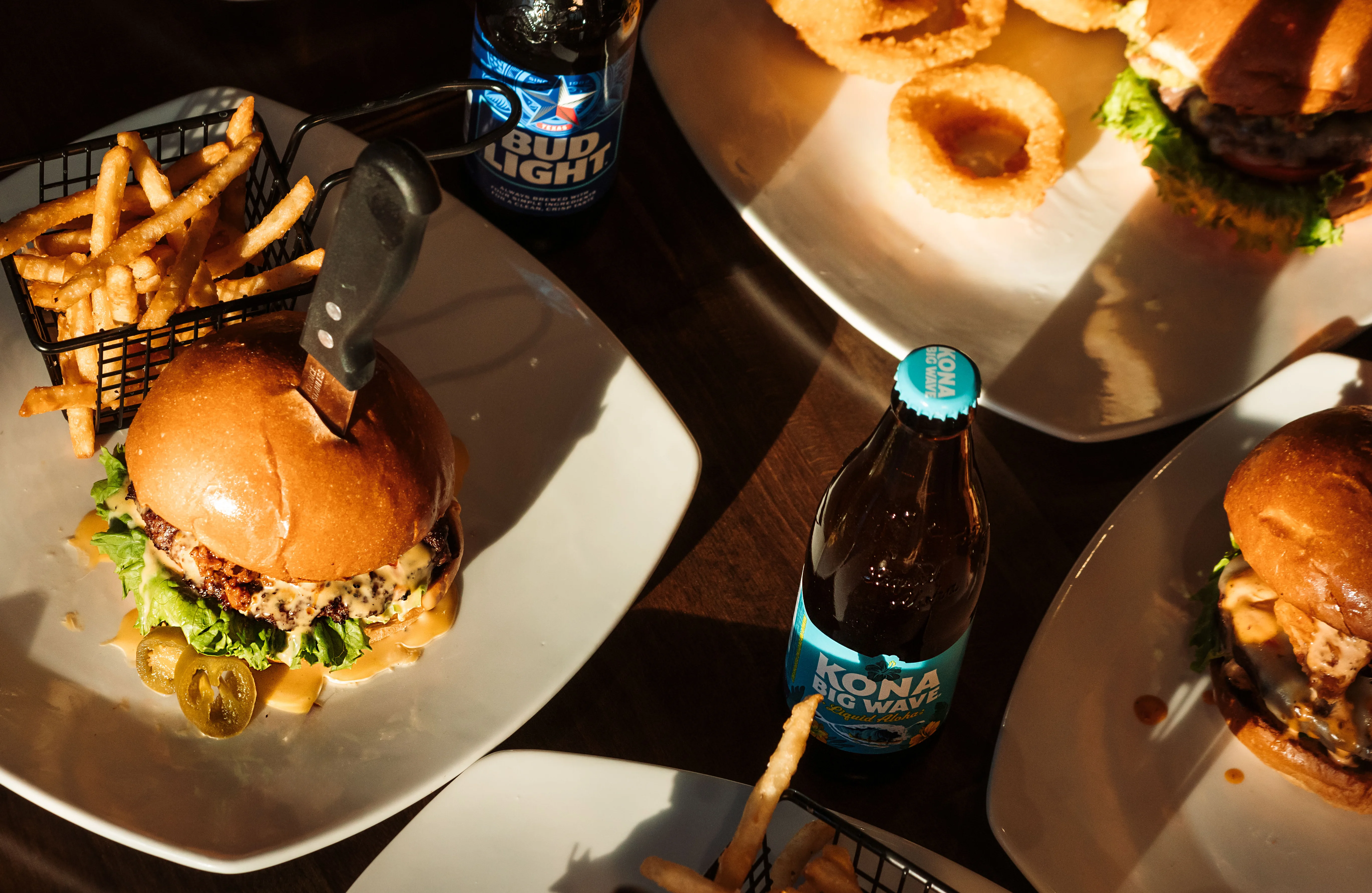 Delicious gourmet burger with fresh toppings on a wooden table.
