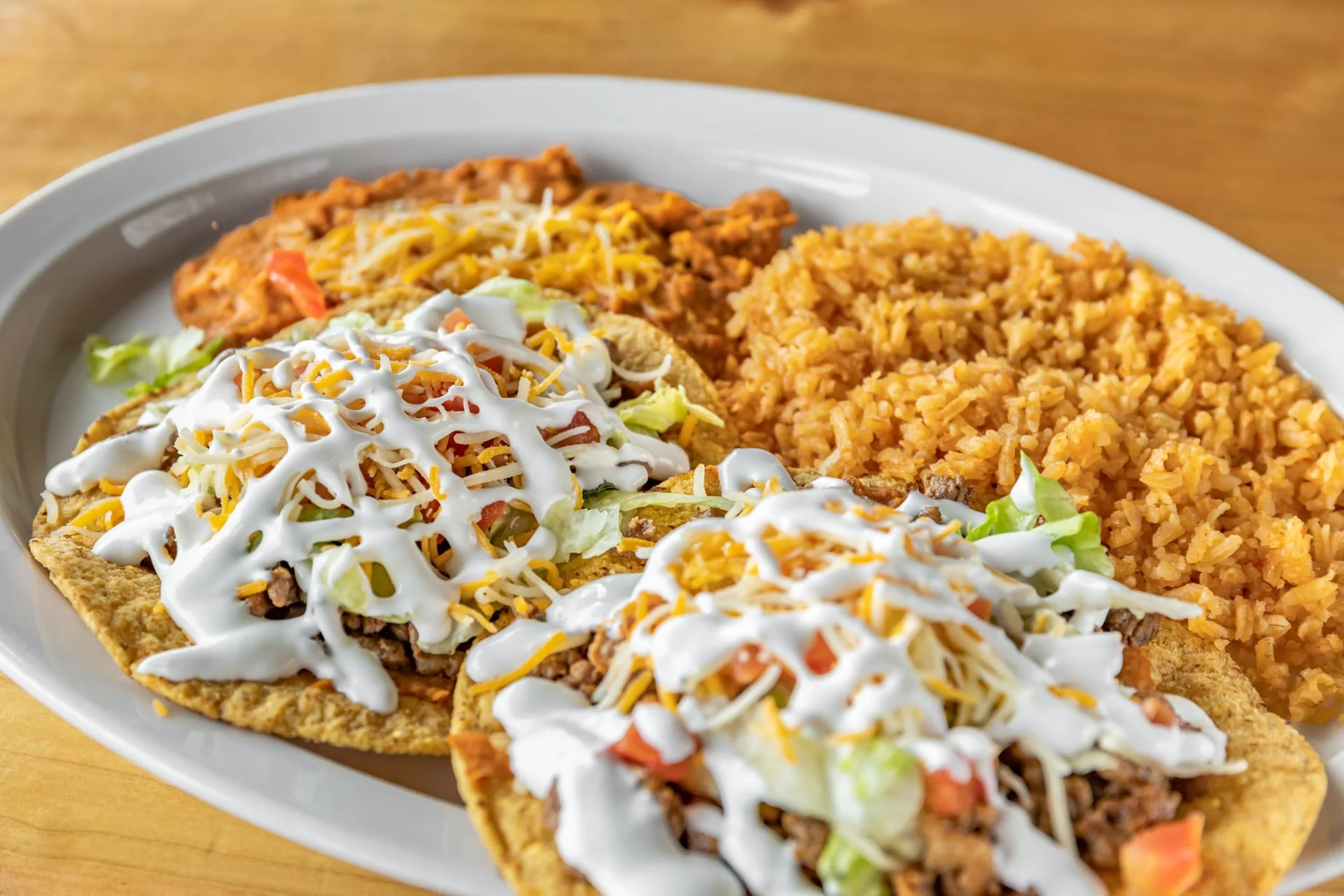 Plate of Mexican tacos with rice and beans