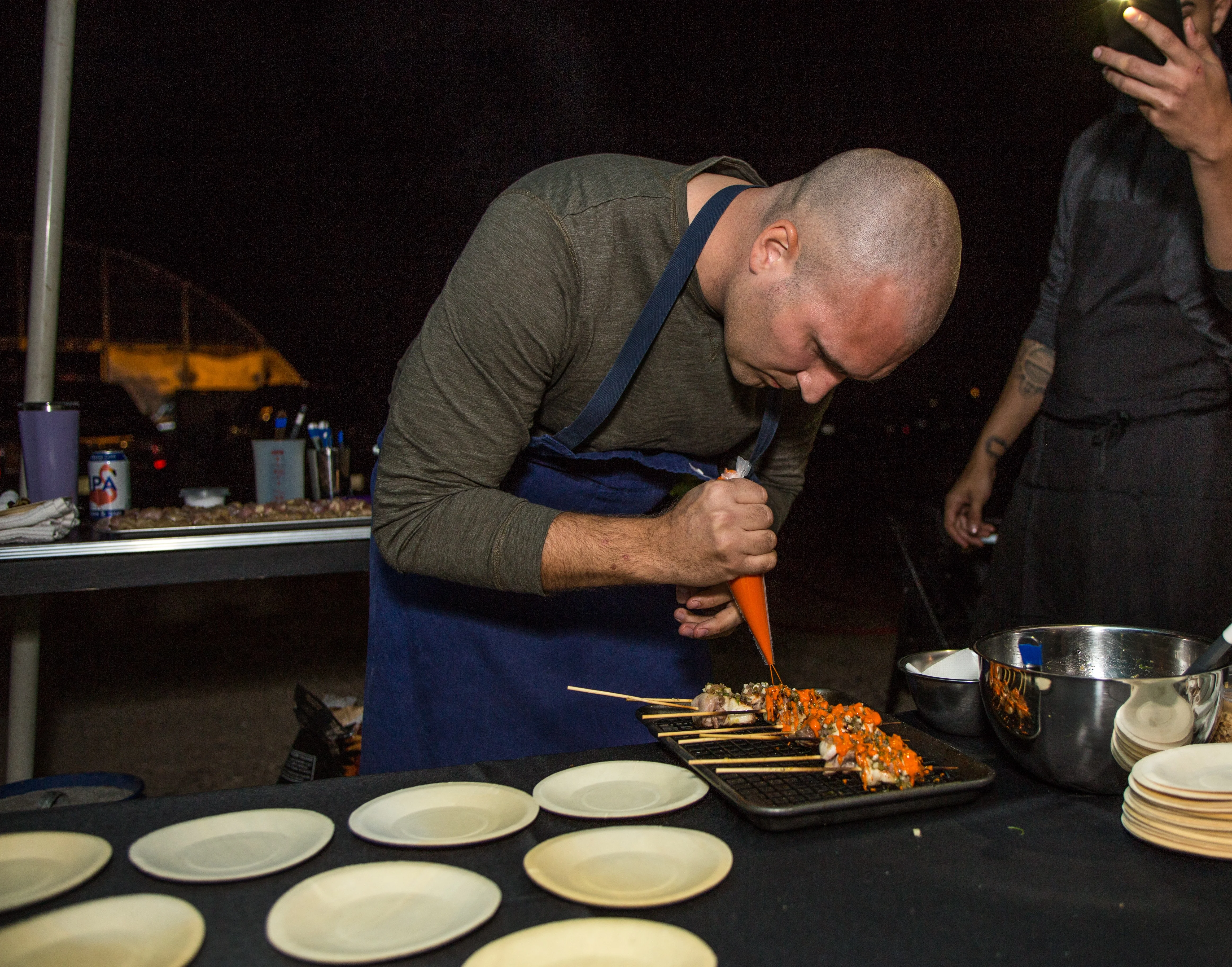 Chef preparing sushi rolls with vibrant toppings
